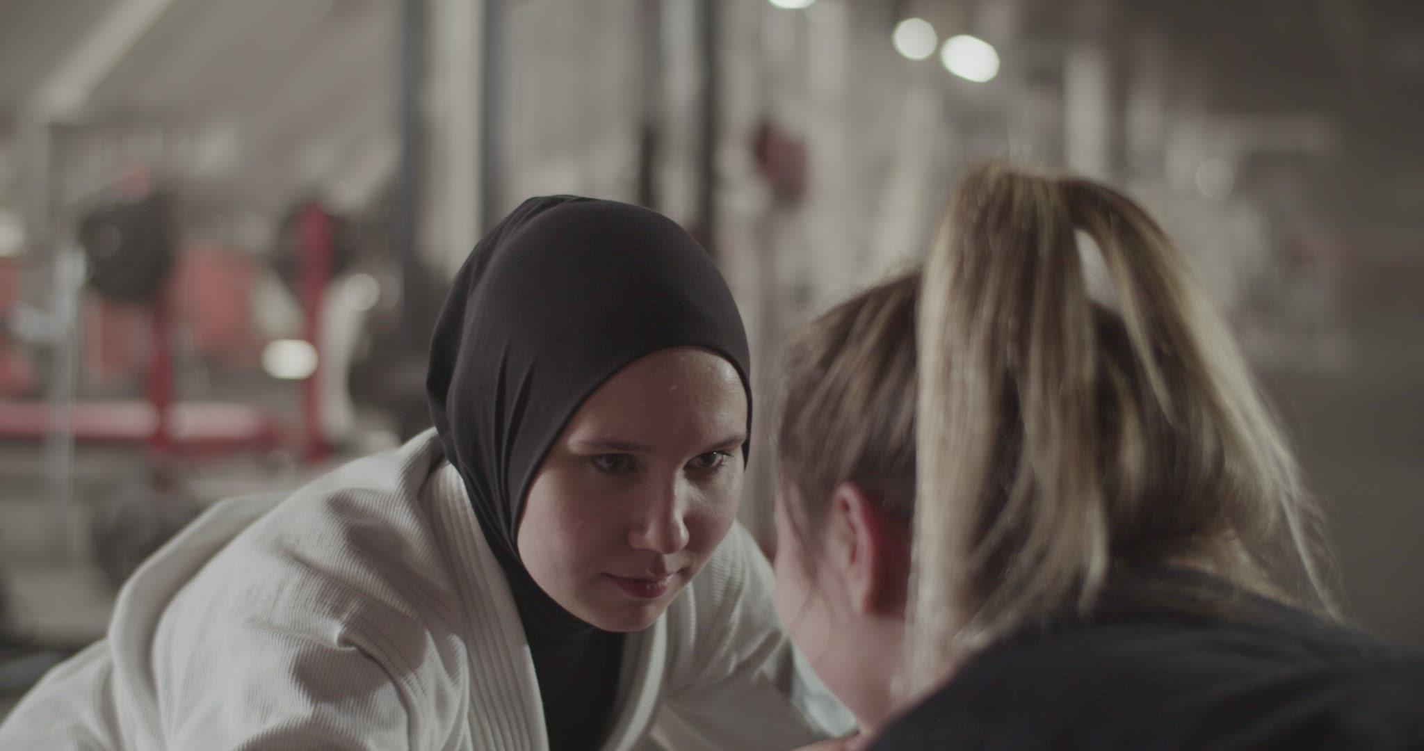 Muslim woman fighting with blond opponent