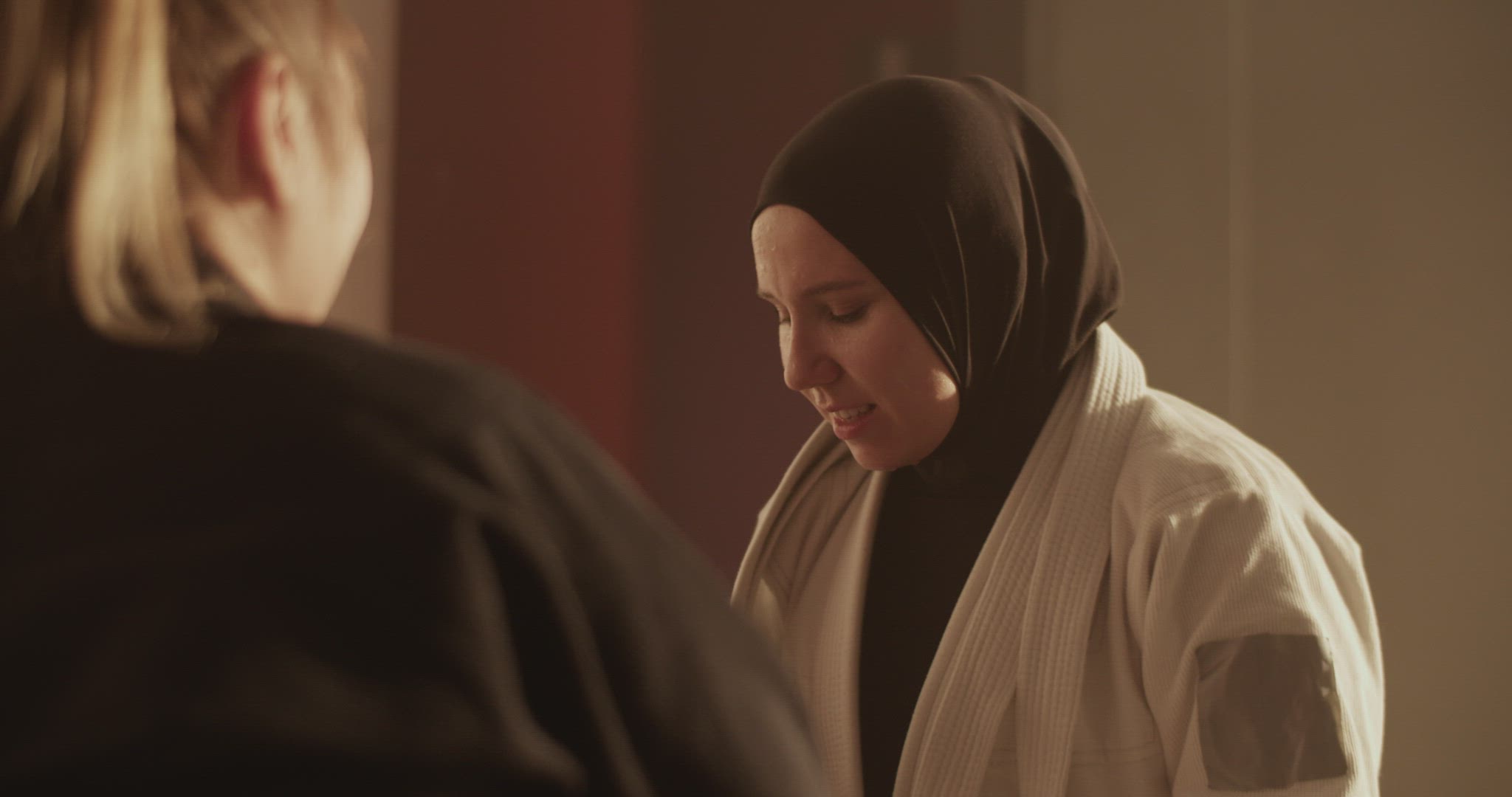 Muslim fighter drinking water and speaking with trainer