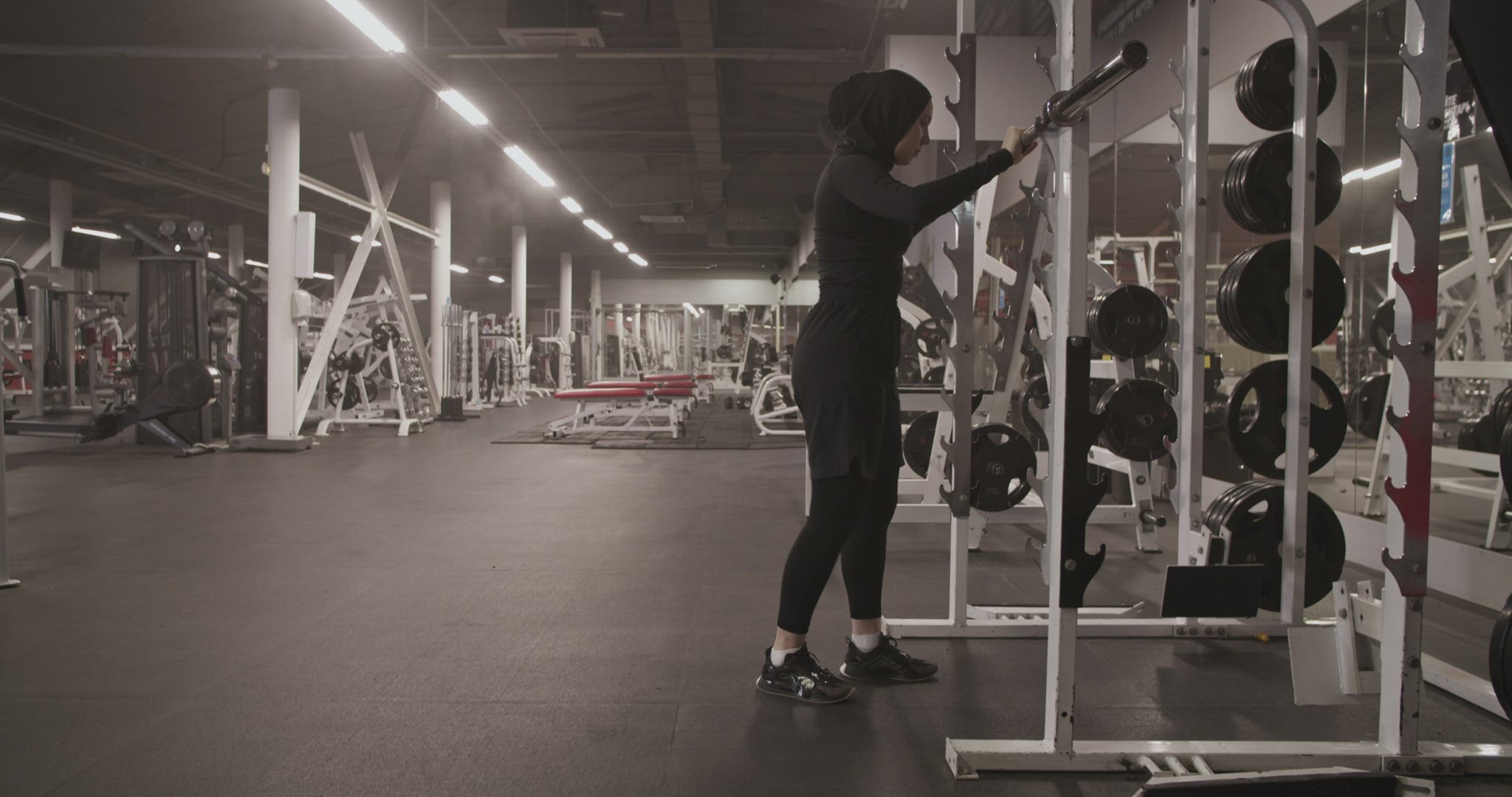 Female athlete squatting with barbell