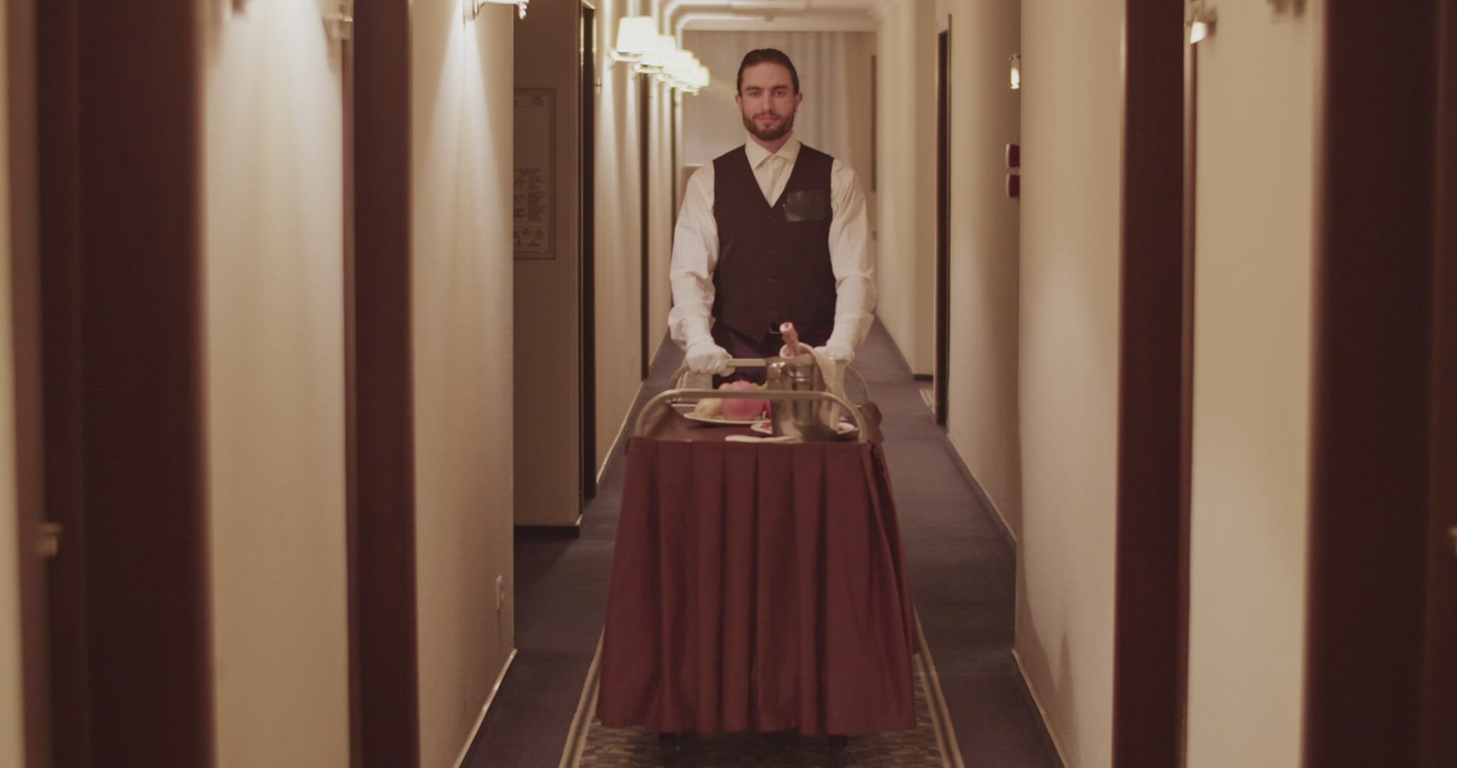 Elegant room service waiter rolling cart in hotel hall