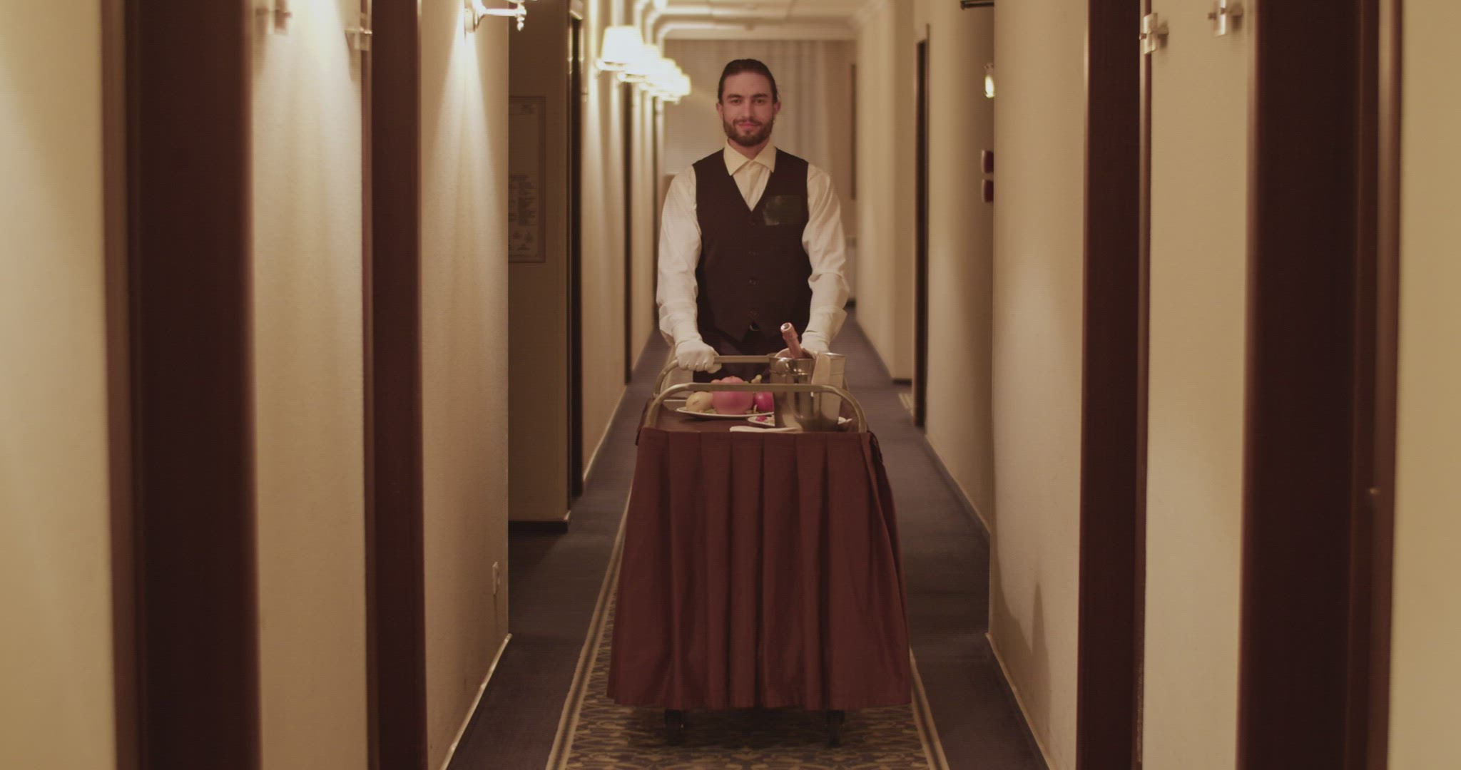Elegant room service waiter rolling cart in hotel hall