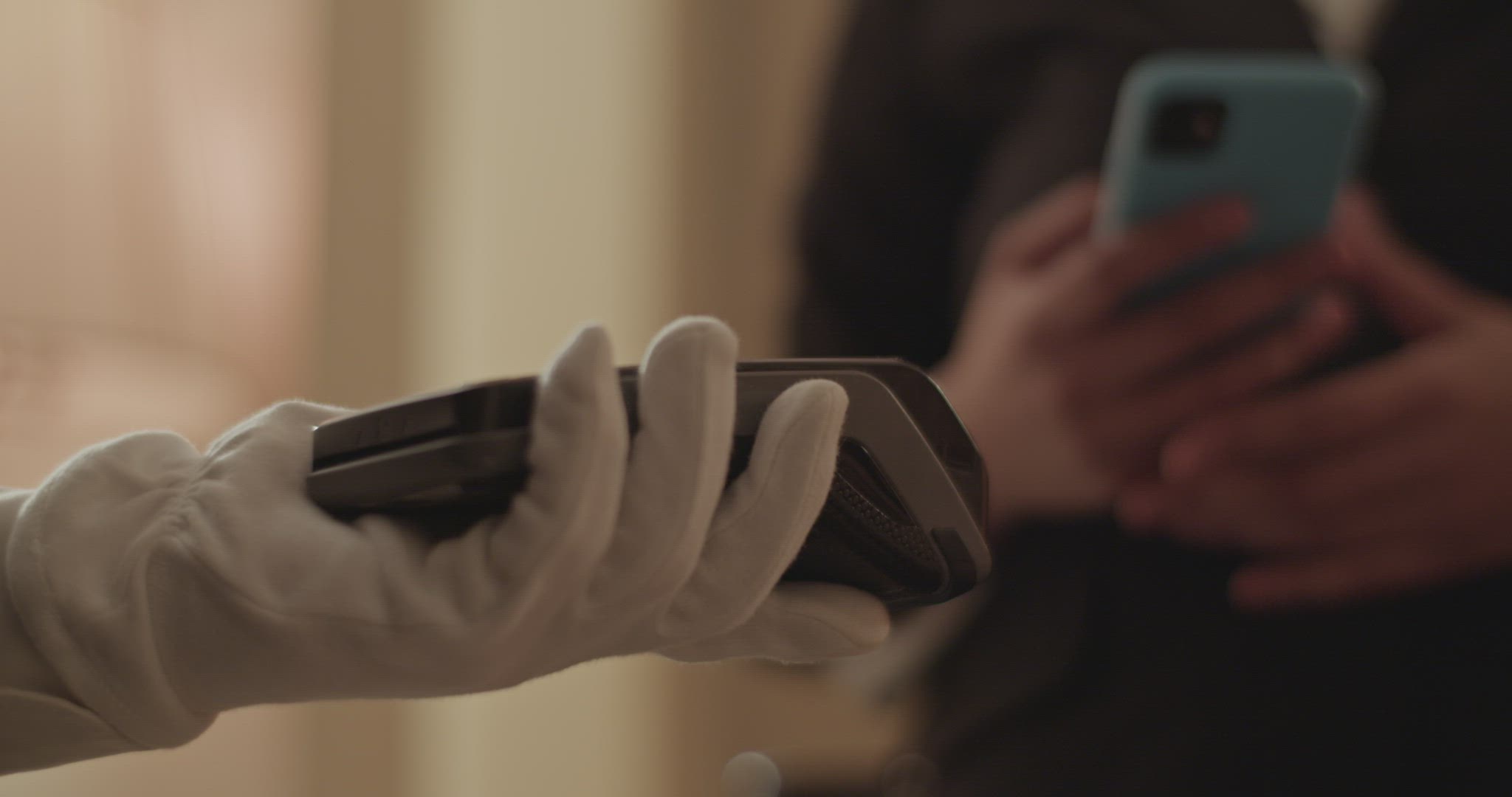 Crop woman using smartphone while paying for room service contactless