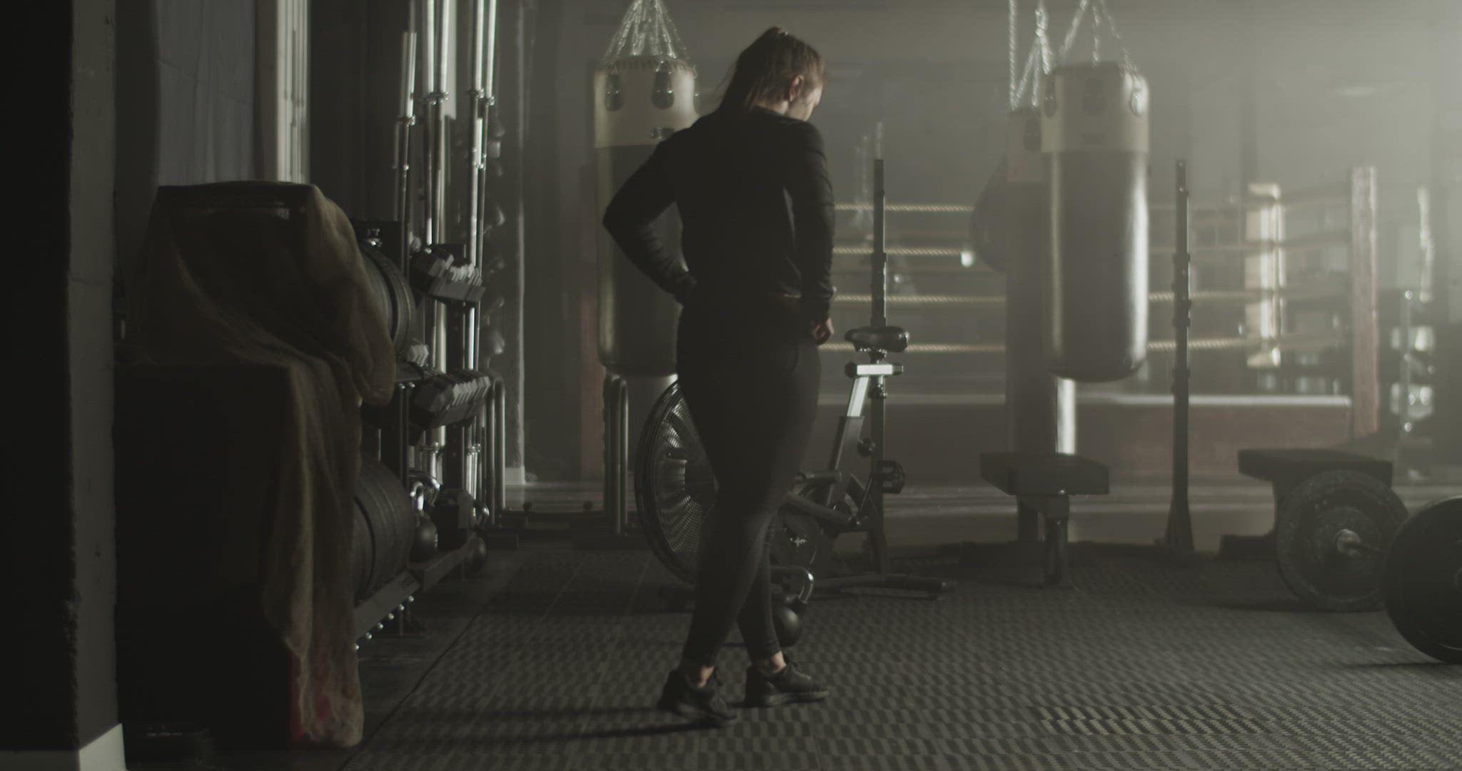 Powerful sportswoman walking in gym during training