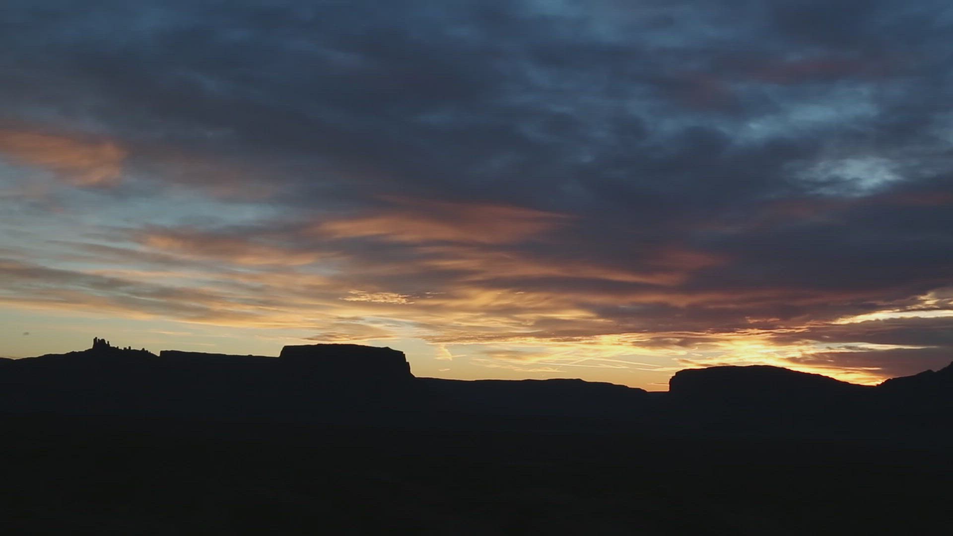 Silhouetted Mesas Below Evening Sky