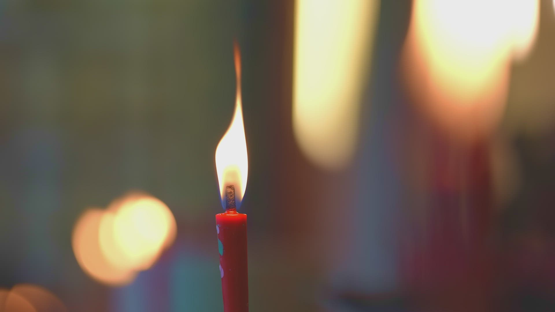 Select focus red candle pray at altar