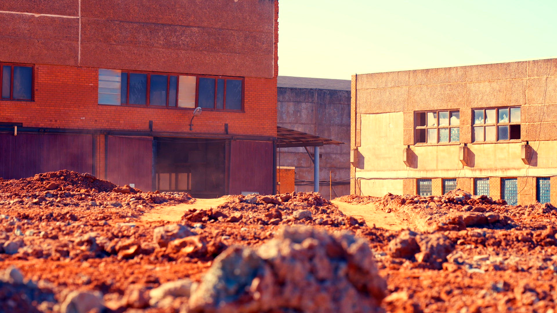 Dump truck appears on horizon driving towards camera.