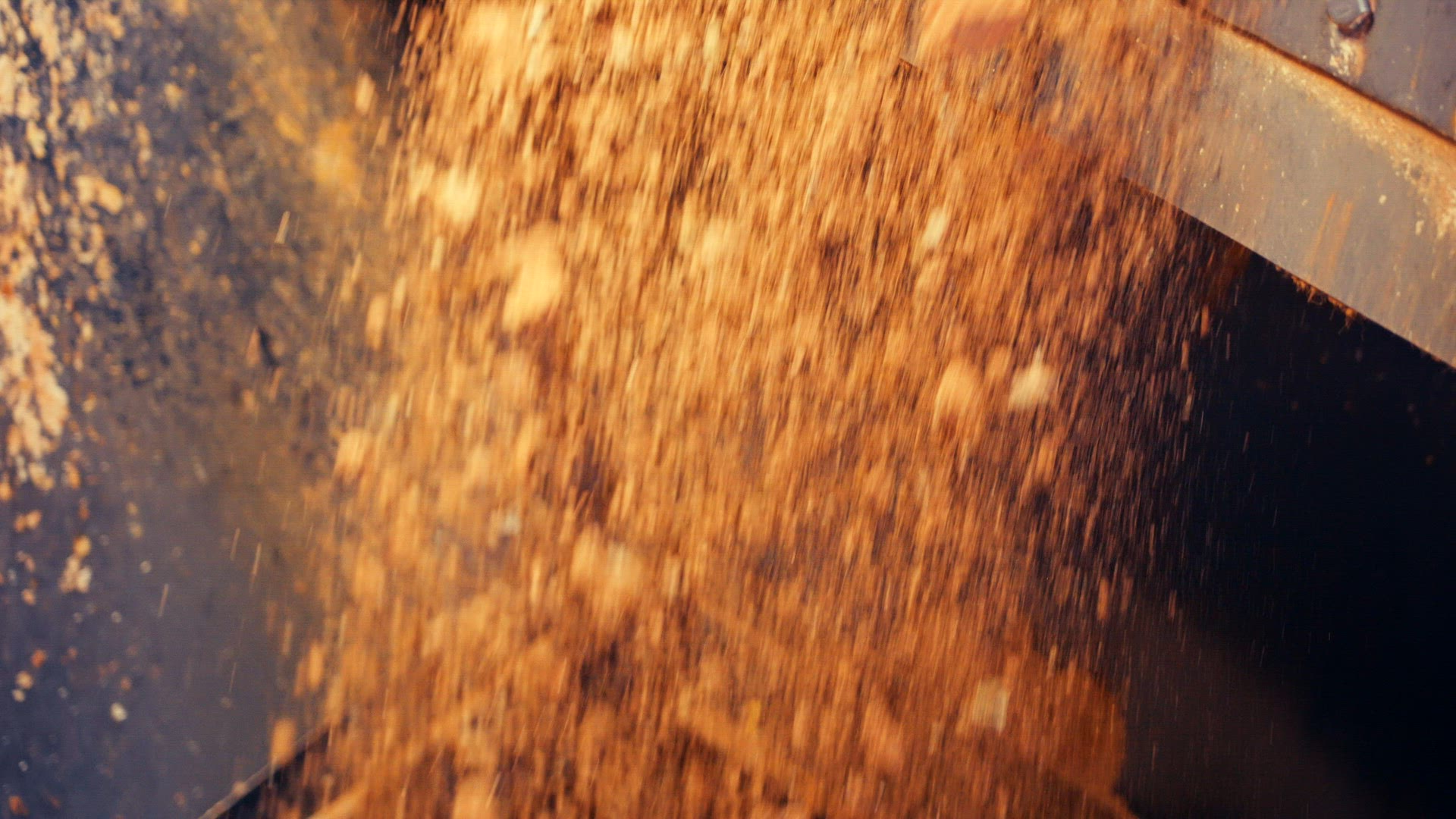 Clay stones falling into crusher from conveyor belt