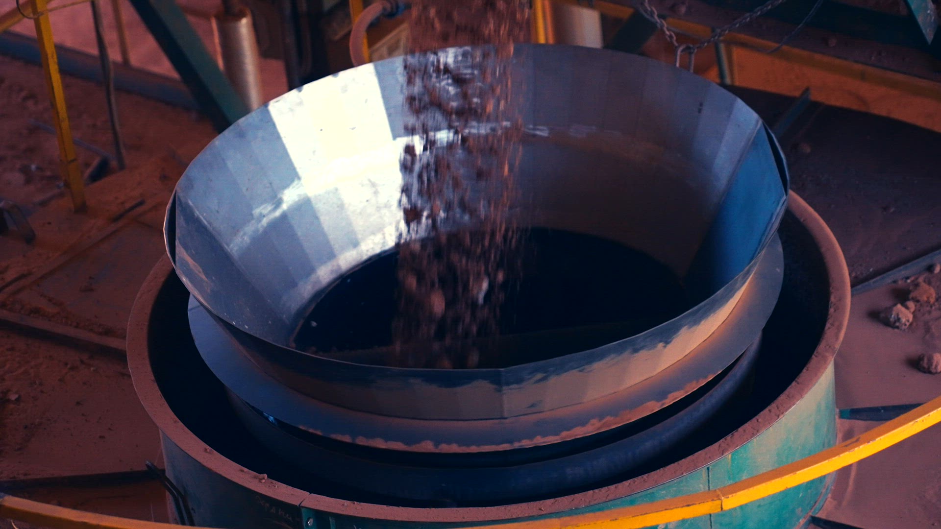Clay stones falling into crusher from conveyor belt