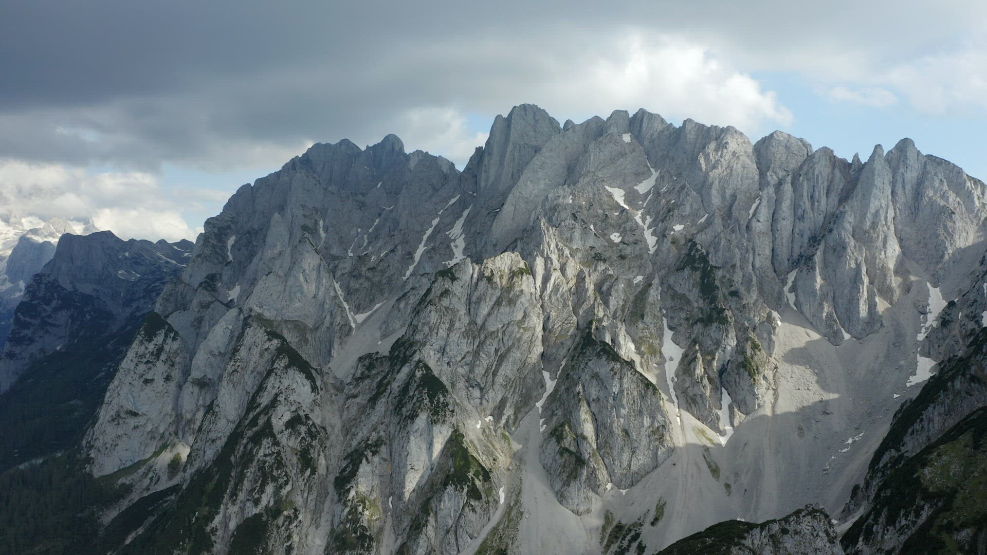 Aerial circle fly around Dachstein top summit mountain top located near Hinterer Gosausee lake Upper