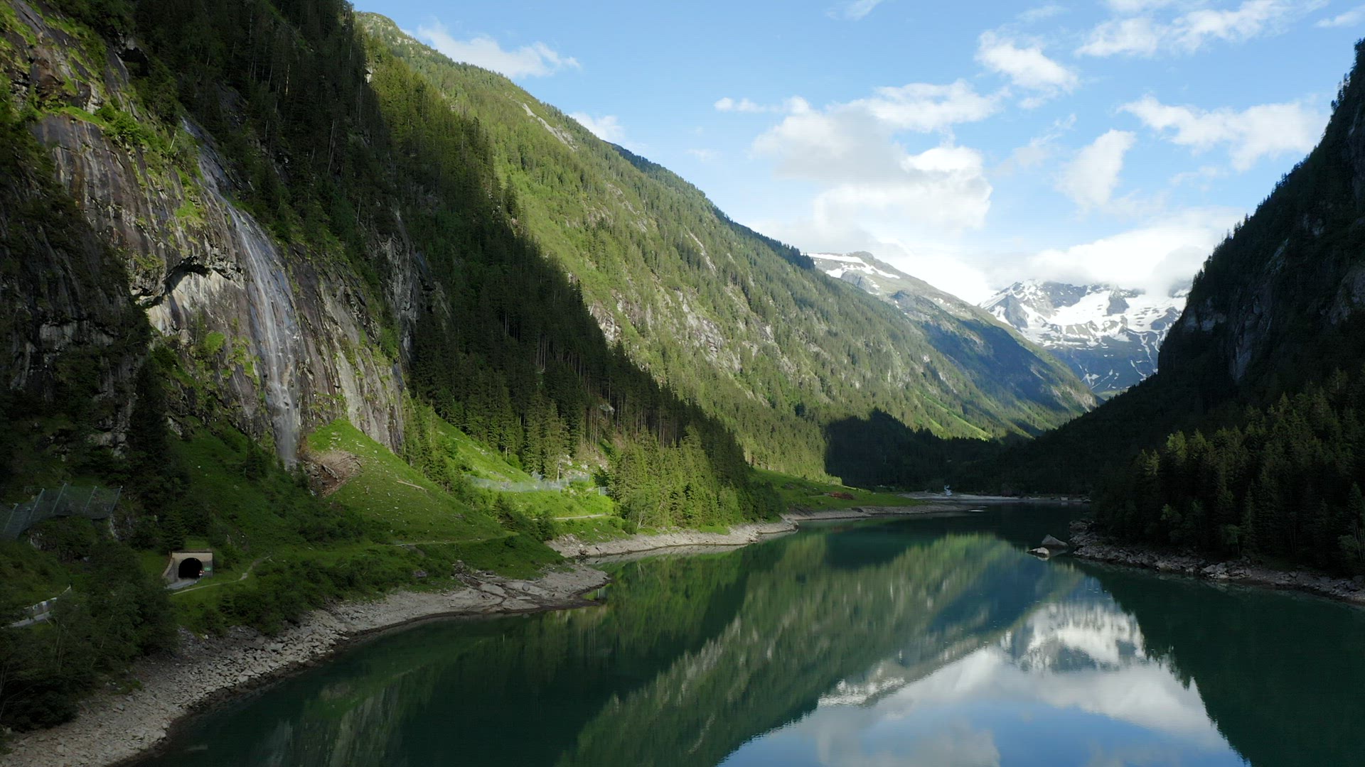 Austria, Tyrol. Aerial towards movement with view of Stillup Lake and pinetree forest around.