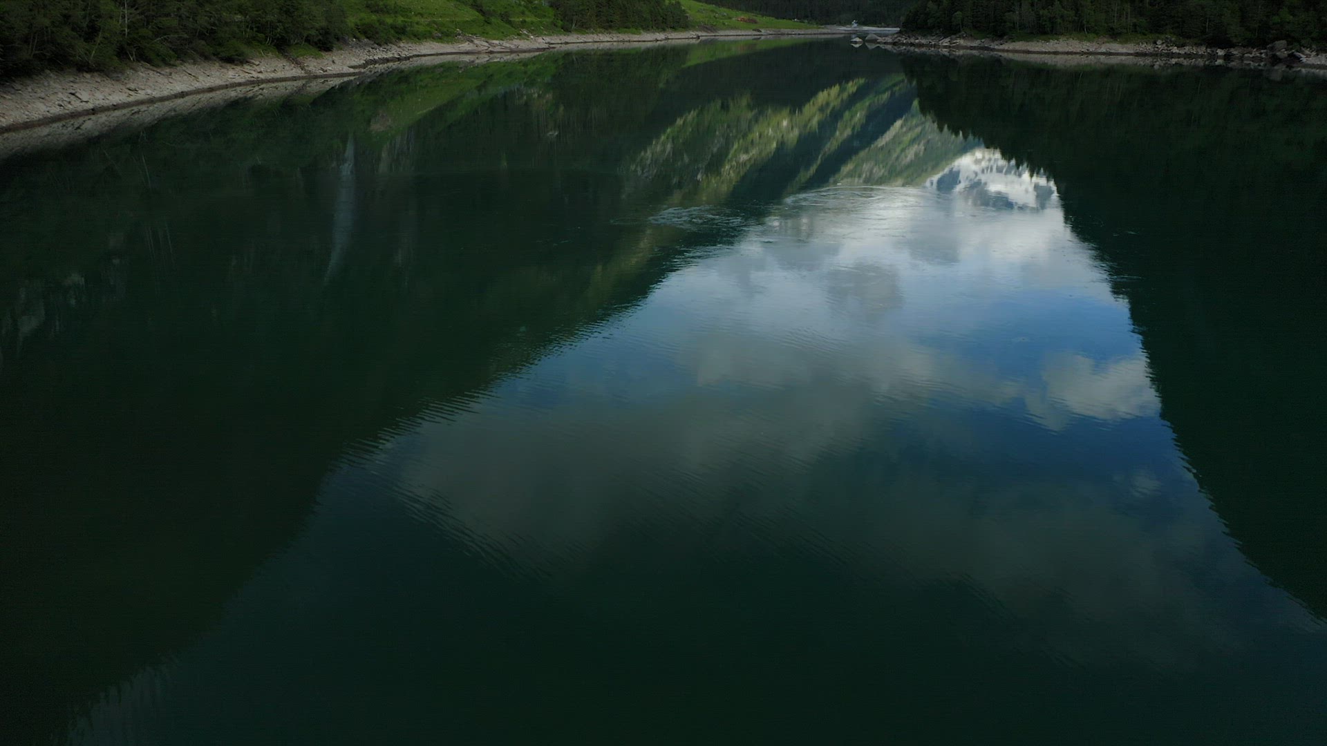 Aerial reveal faatage starting with lake and ending with Mountain. Stillup, Austria, Tirol