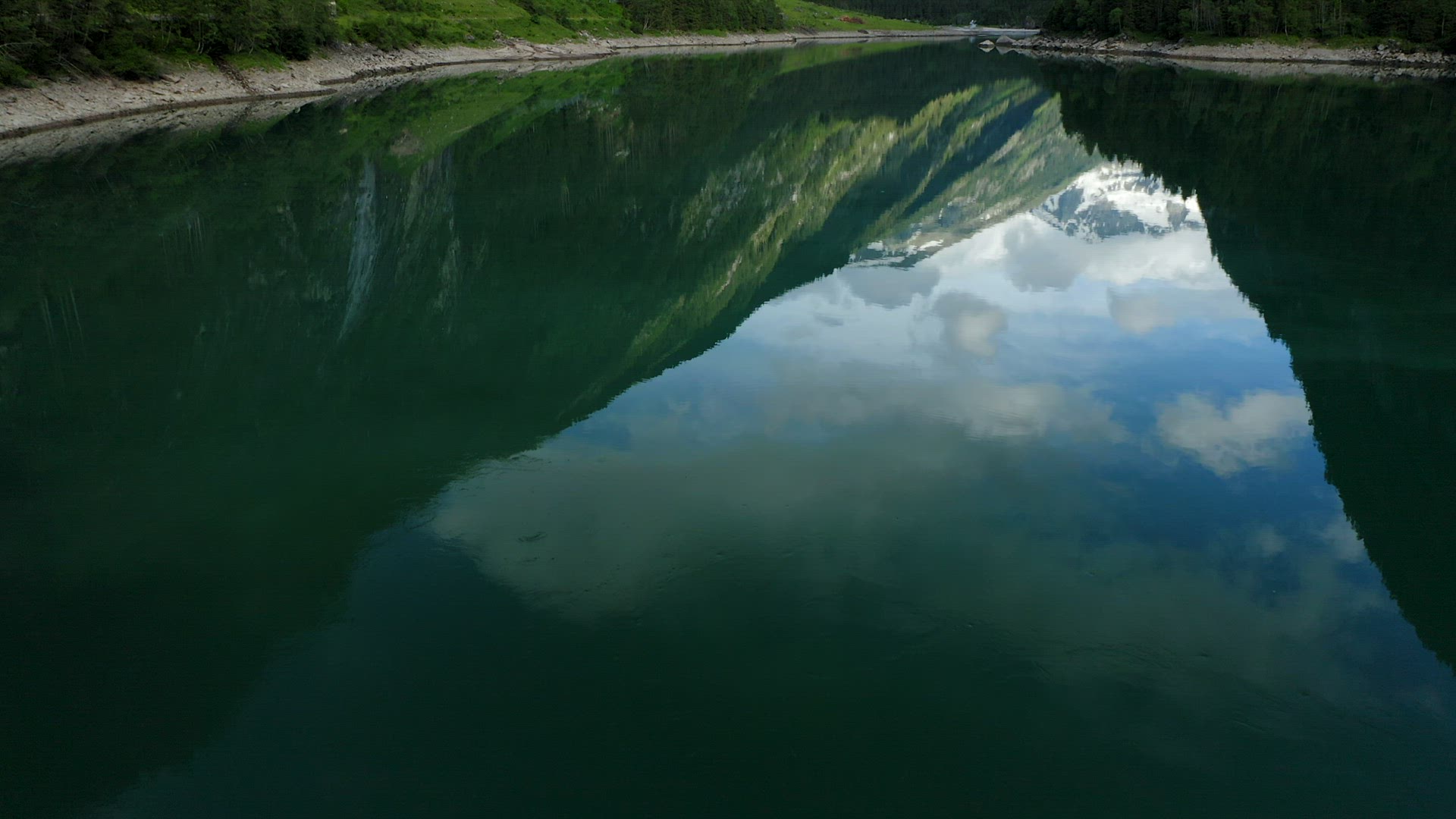 Aerial reveal movement of Mountain above lake Stillup, Austria, Tirol