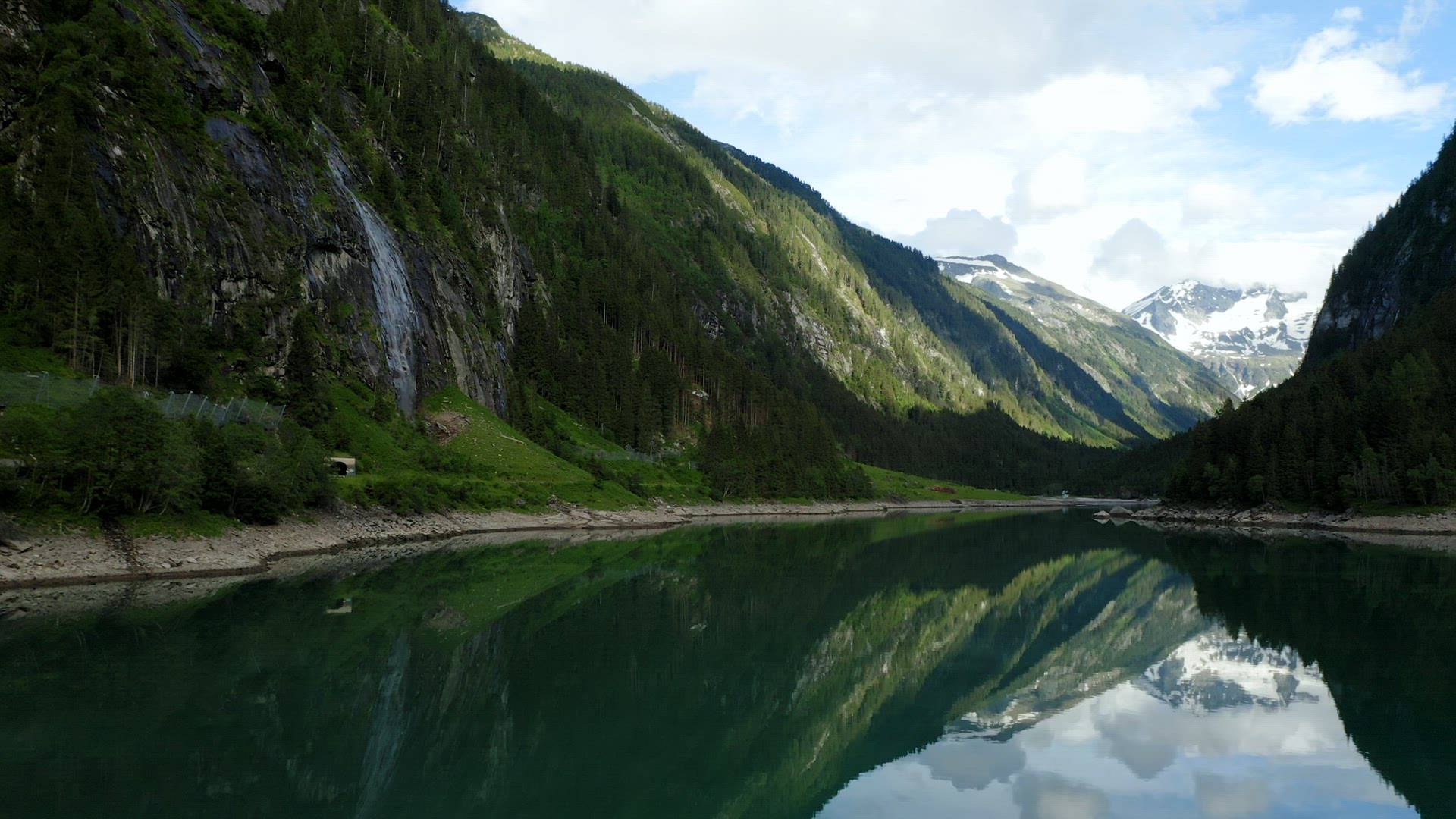 Aerial fly above water surface of Mountain lake Stillup, Austria, Tirol