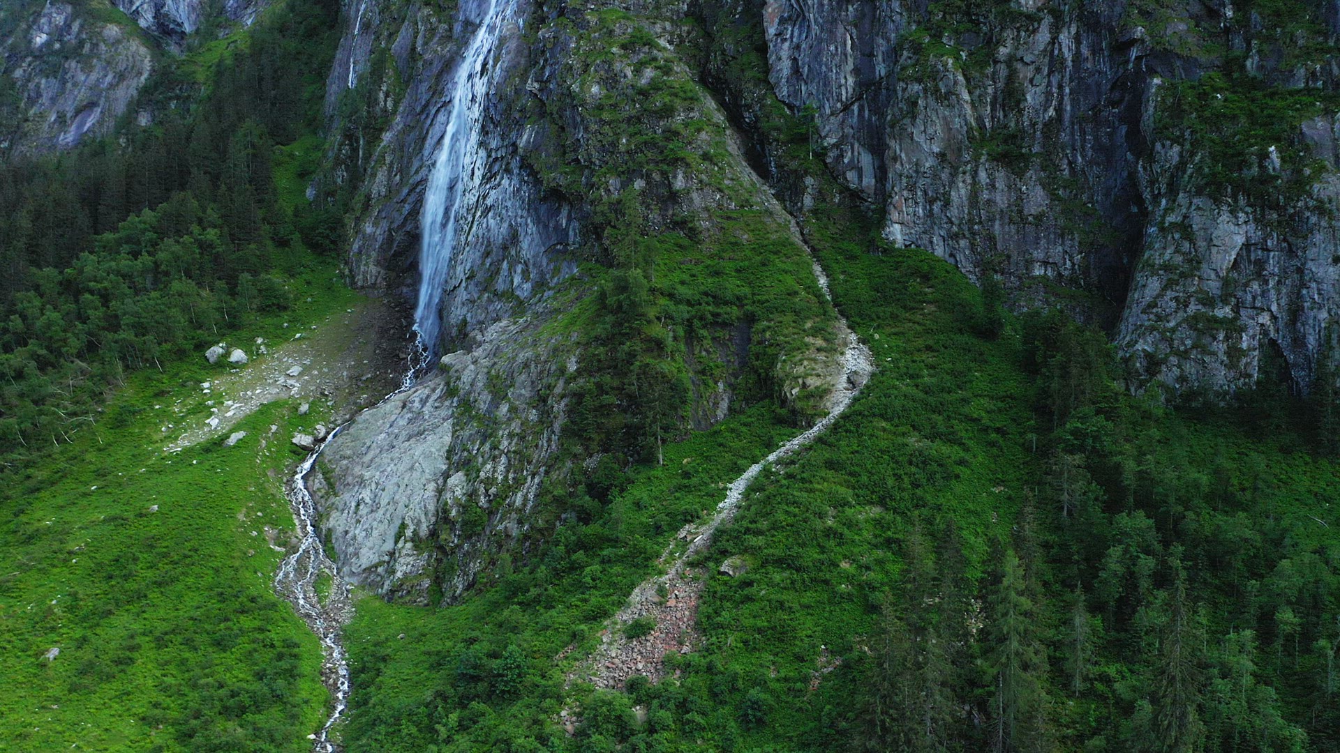 Austria, Tyrol. Aerial view of impressive rocks and mountain waterfall. Stillup Lake,