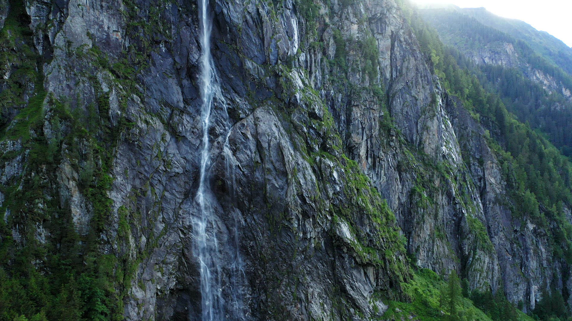 Aerial fly out from mountain waterfall. Stillup Lake, Austria, Tyrol