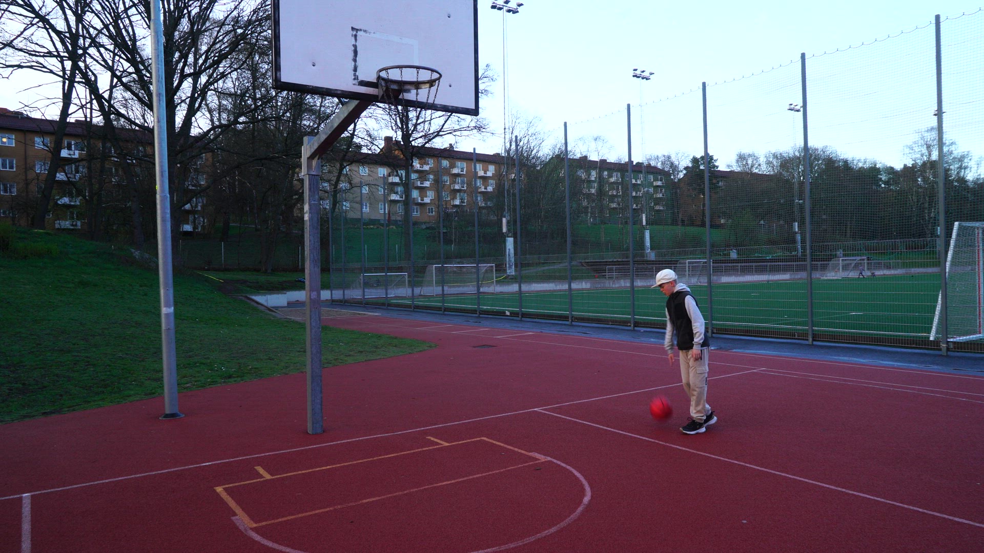 young boy training basketball at playgound - misses shot