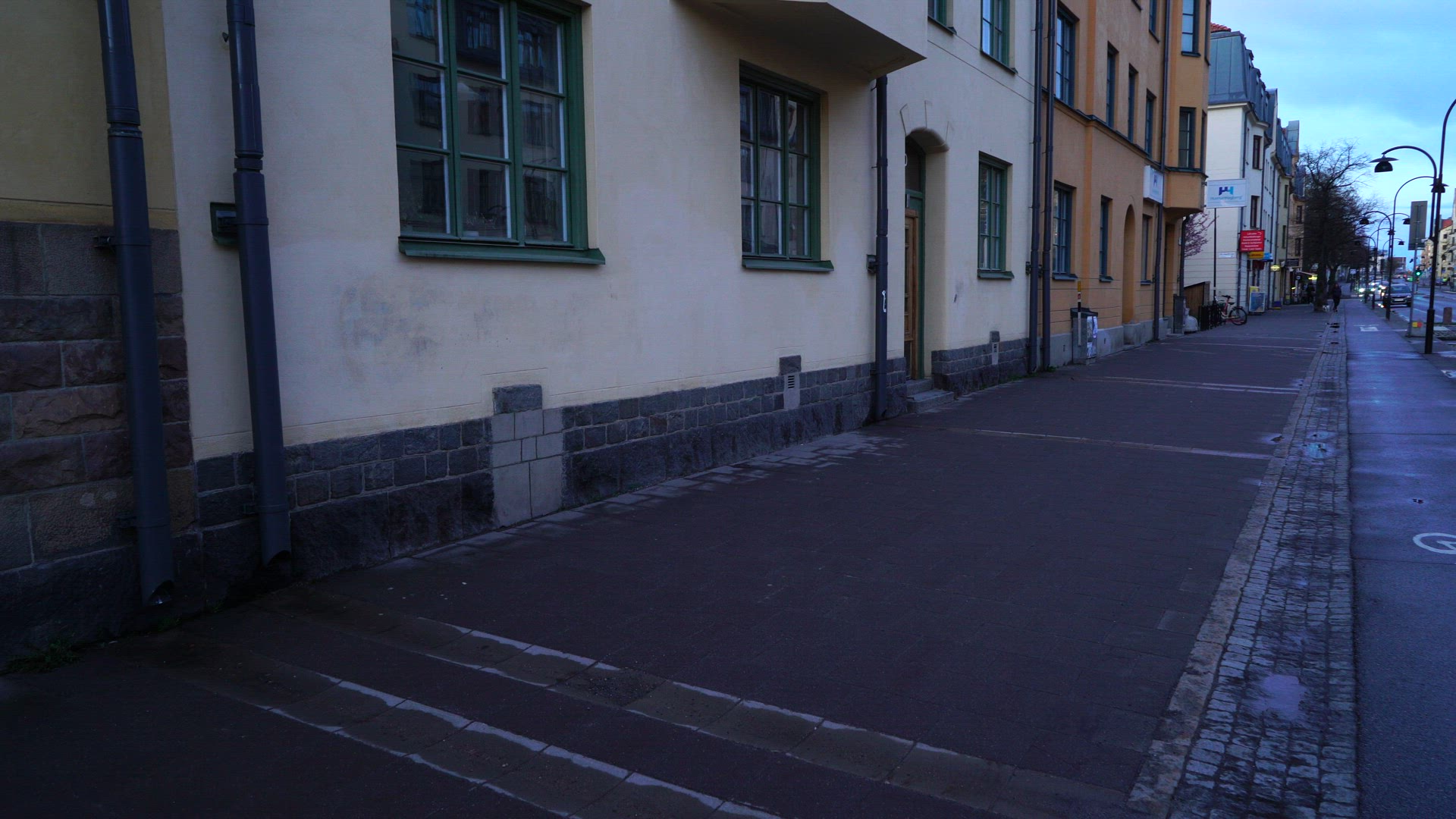 boy walking on sidewalk in stockholm suburb Aspudden - bouncing basket ball