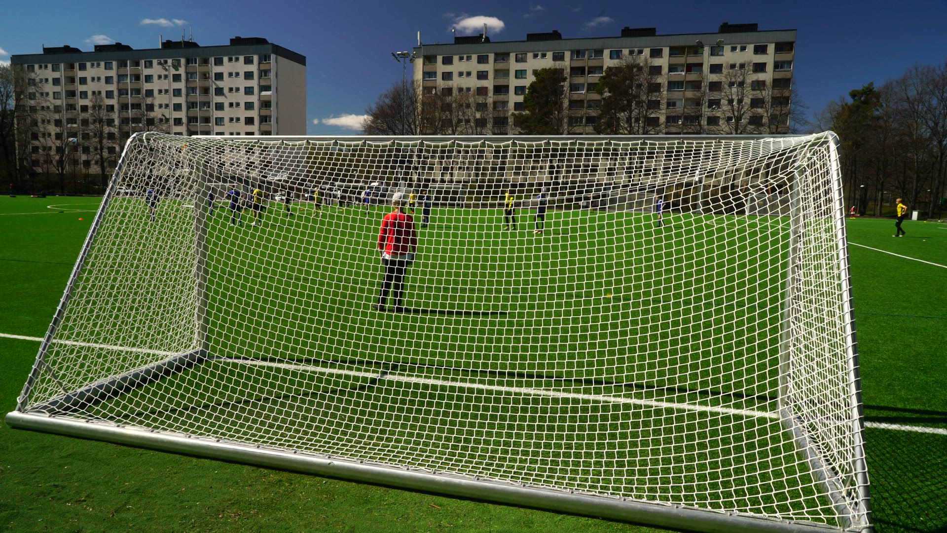 soccer field - soccer goal - young kids playing soccer game - goalkeeper