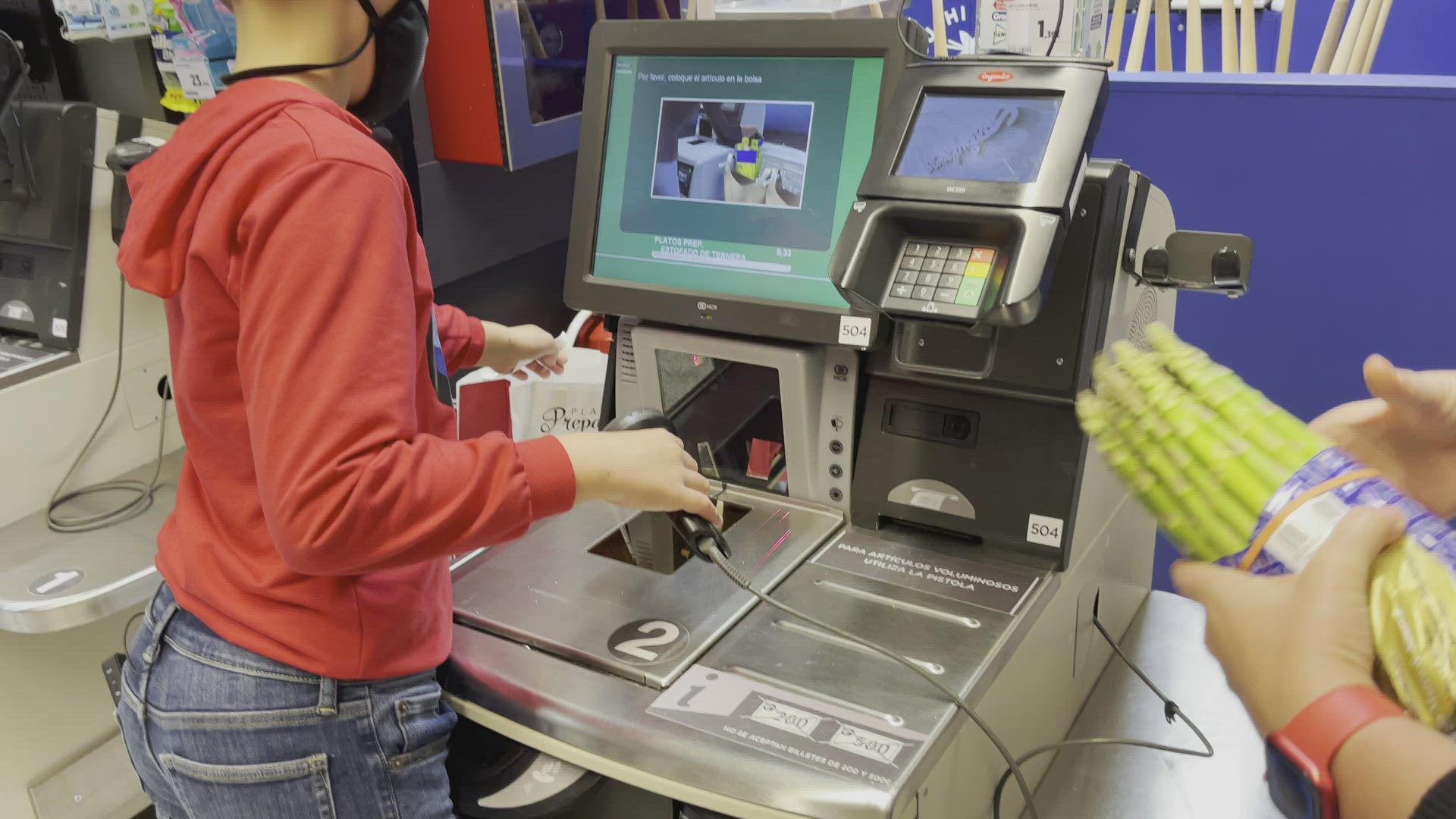 Boy helps mum to buy food in the self-service supermarket