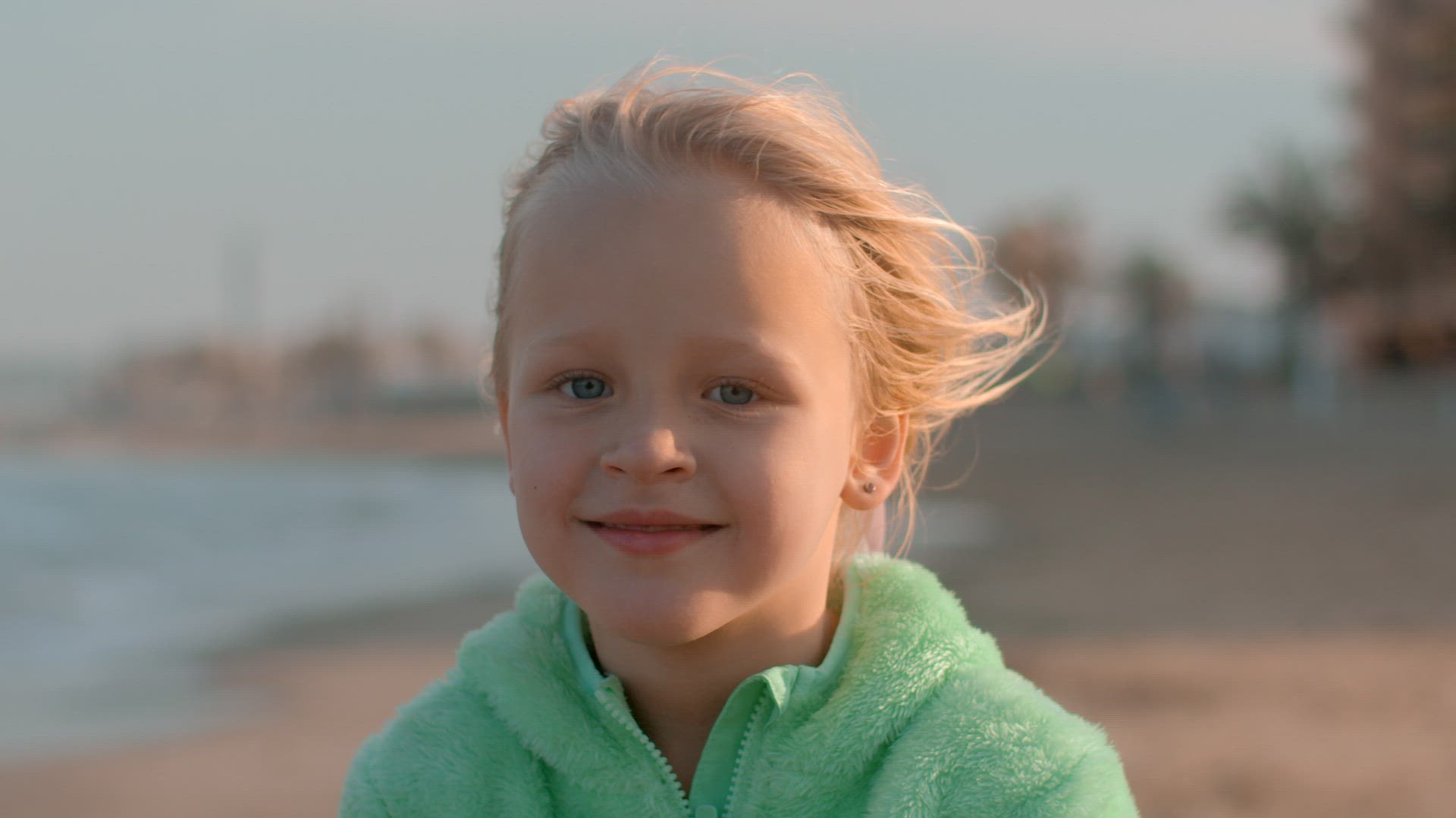 Portrait of a little happy girl on the beach