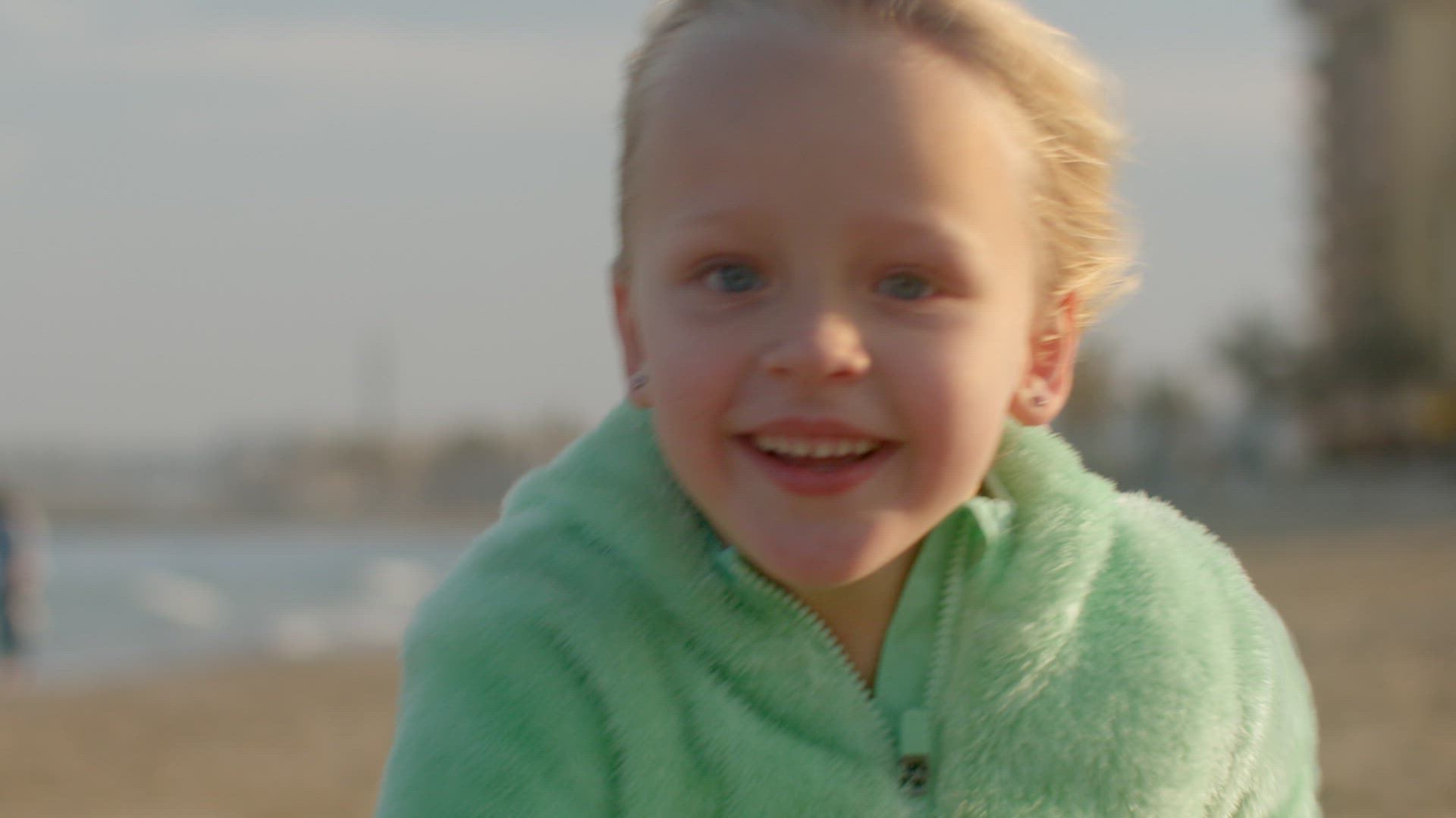 Portrait of a joyful kid running on the beach