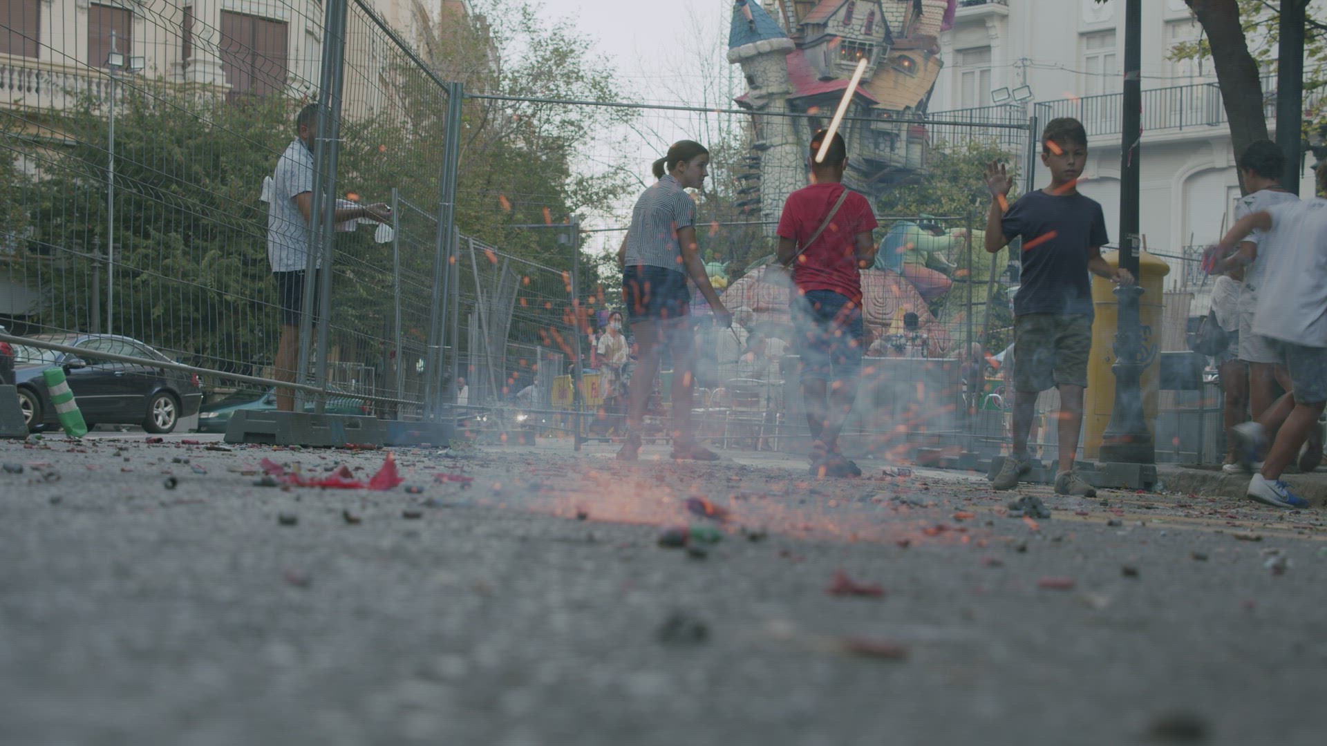 Kids celebrating Fallas festival and launching firecrackers in city street