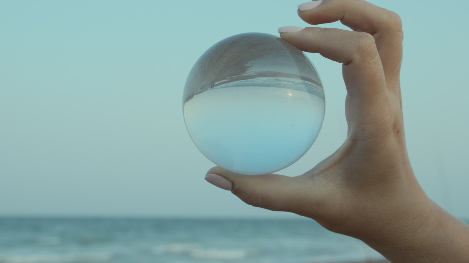 Transparent glass ball in hand