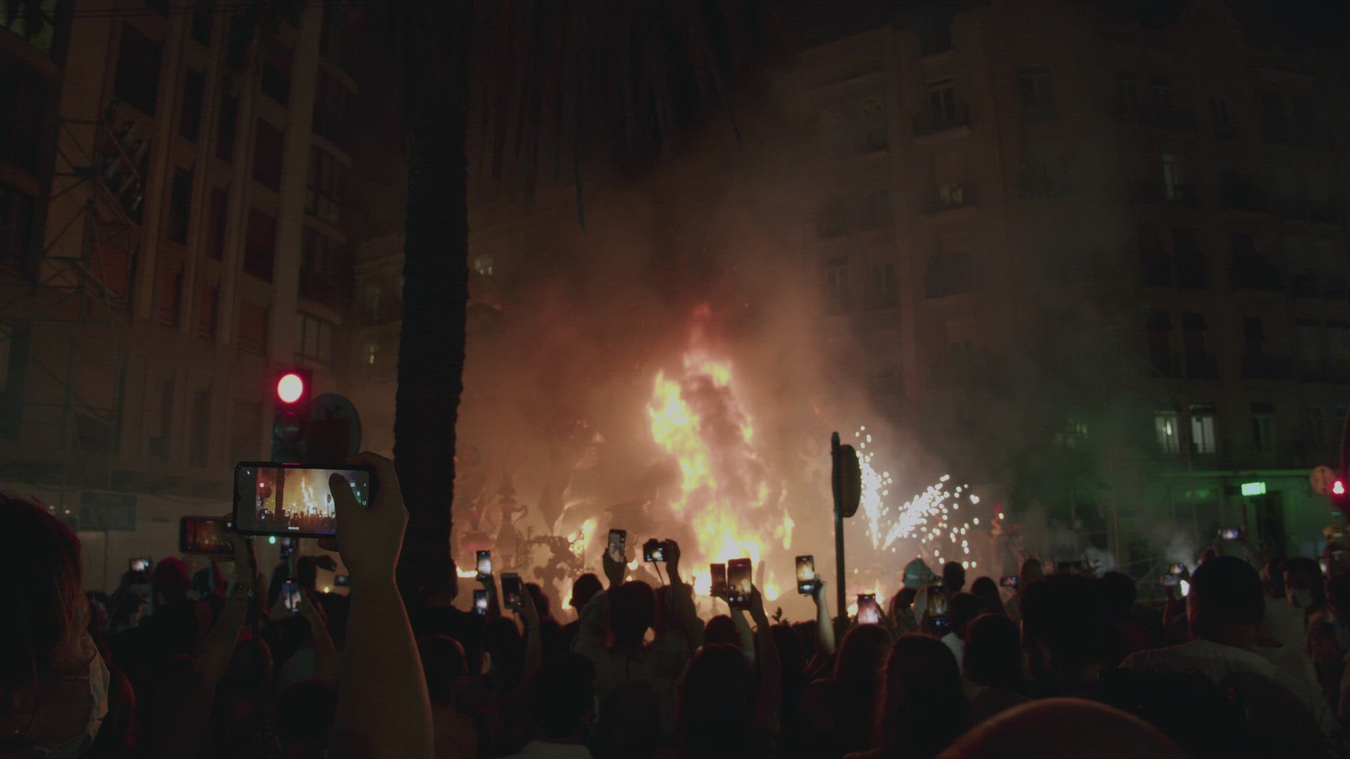 Big bonfire on Las Fallas final night. Crowd of people watching burning ninot