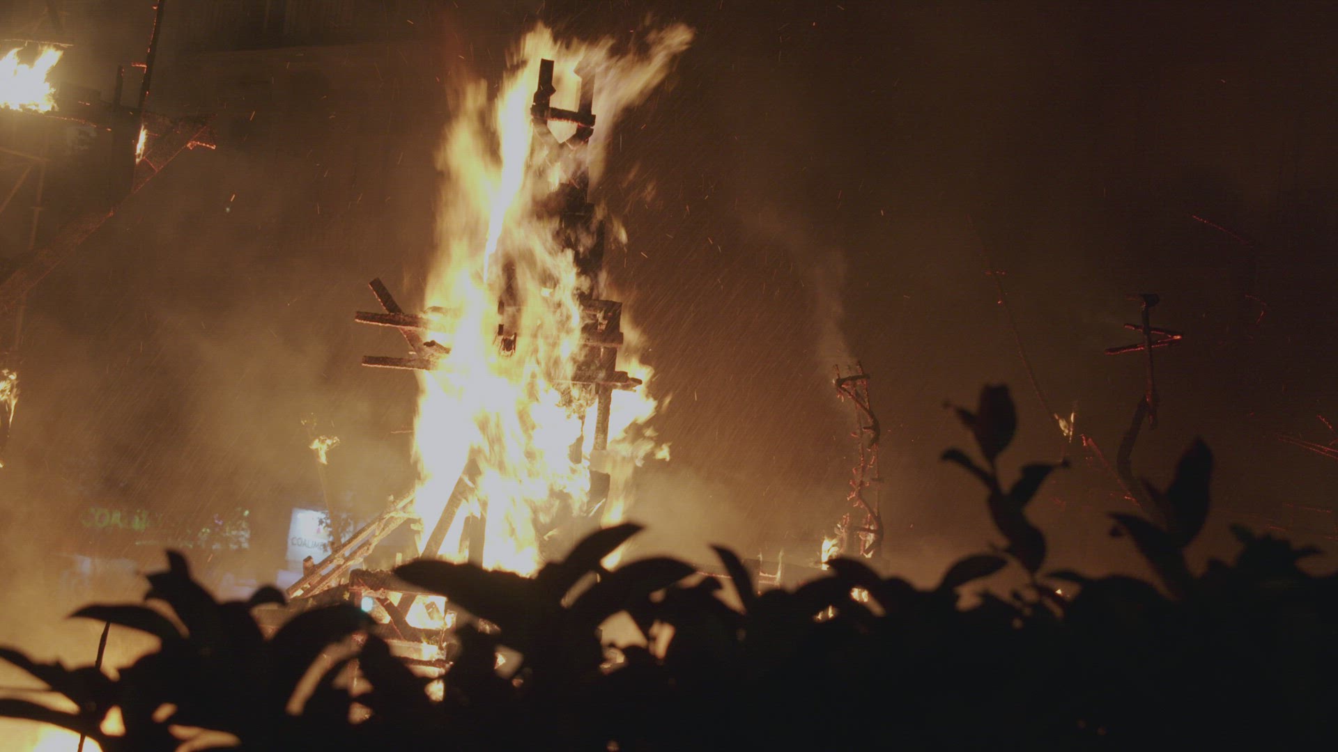 Las Fallas street sculpture is burnt in night festive bonfire, Spain