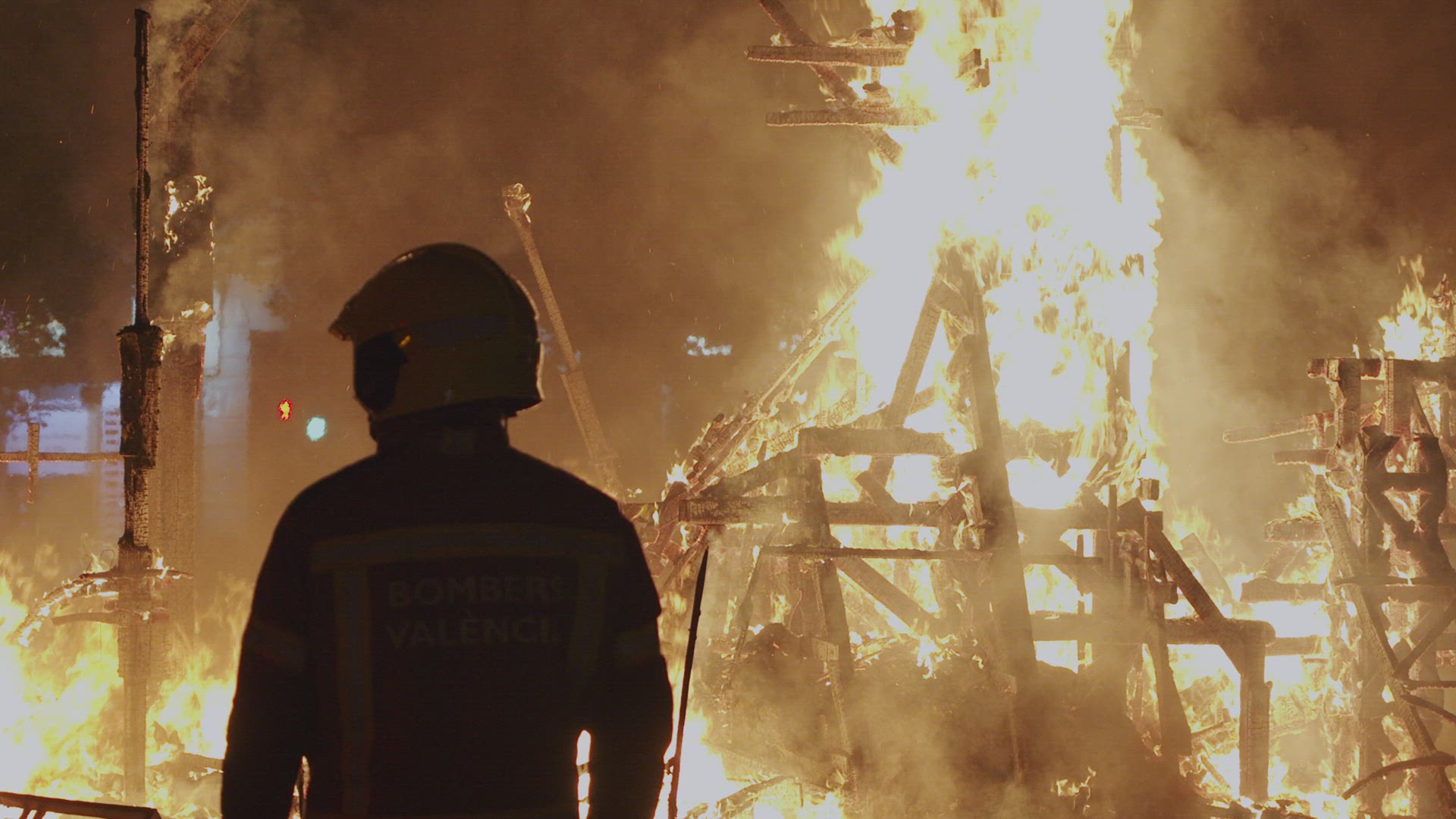 Fireman controls the bonfire of Las Fallas festival in Spain