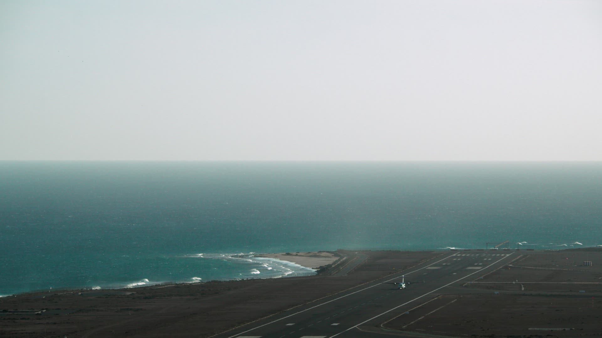 Airplane flying on the background of the sea