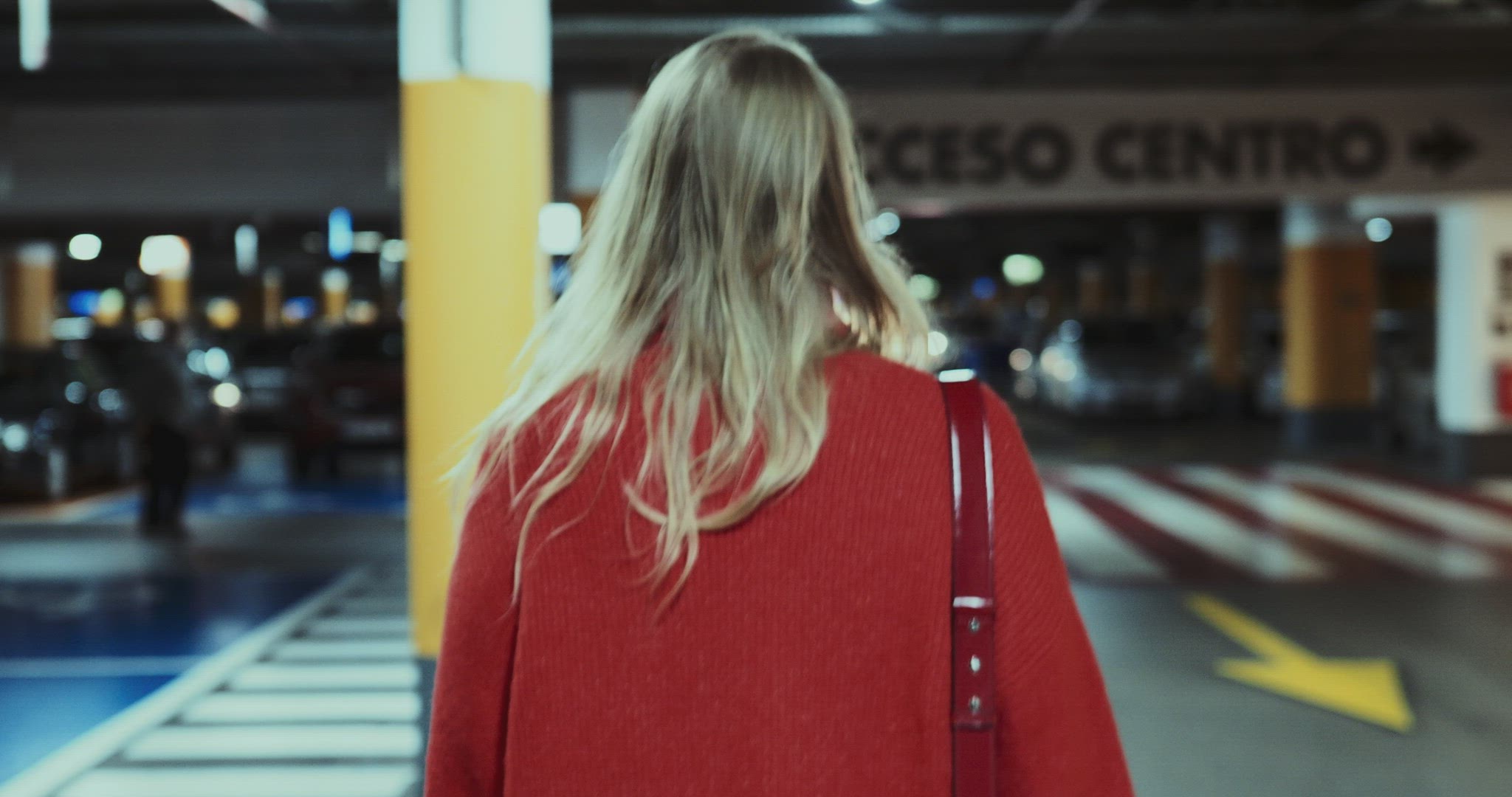The girl walks through the underground parking