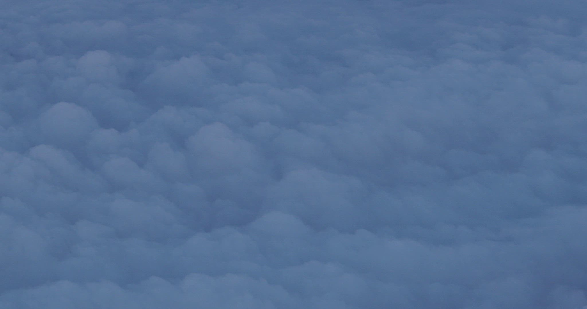 The airplane is flying above the clouds, view from the window