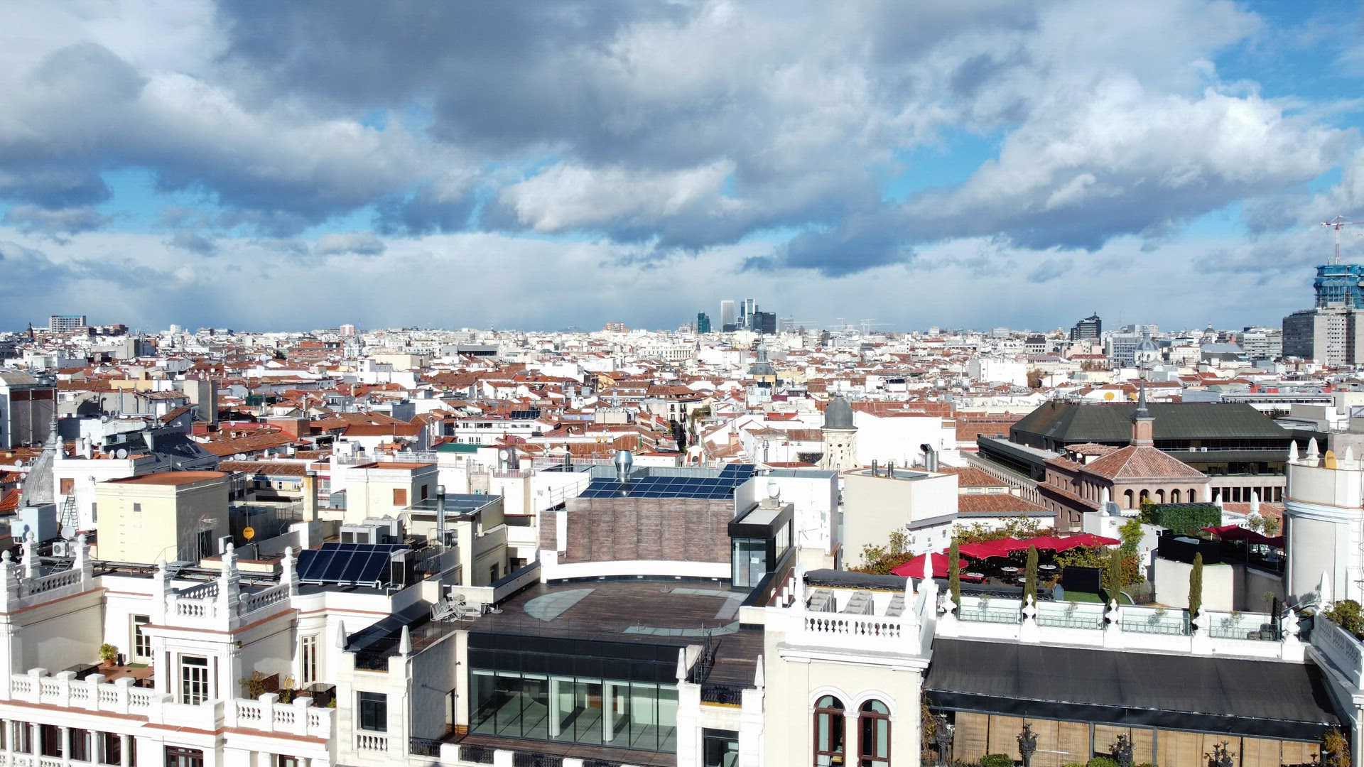Aerial view of Madrid residential quarters, clouds sailing over the city