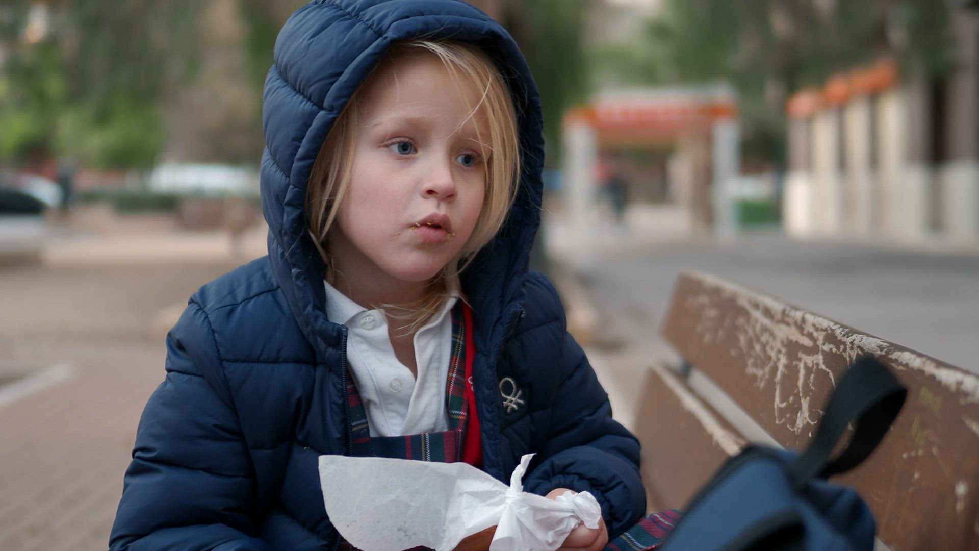 Little girl eating outdoor after school