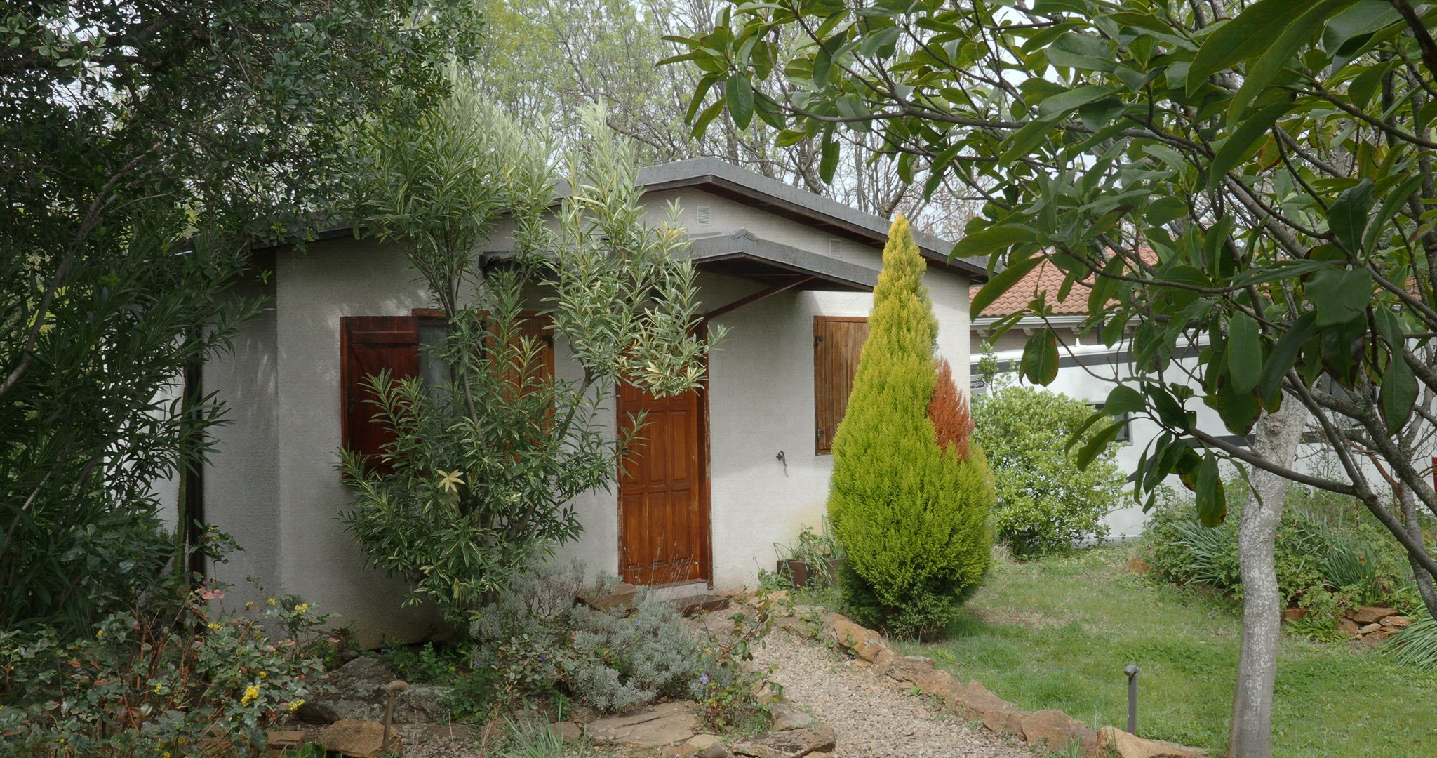 Countryside house among green trees and bushes