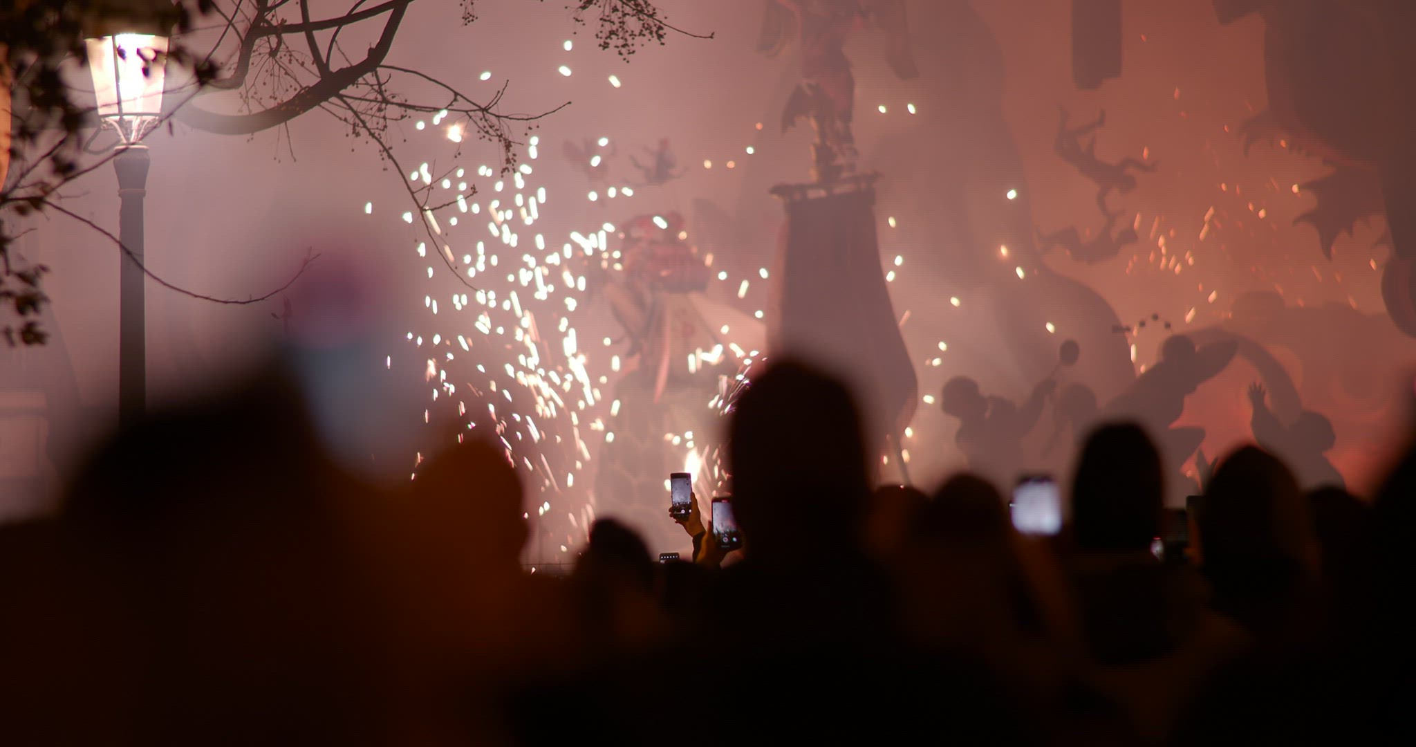 People celebrating Fallas festival and looking at ninot fireworks, Spain