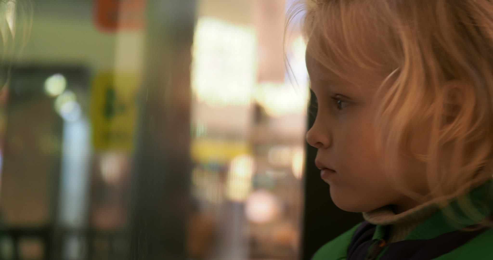 Little kid taking offence to somebody and leaning to the glass