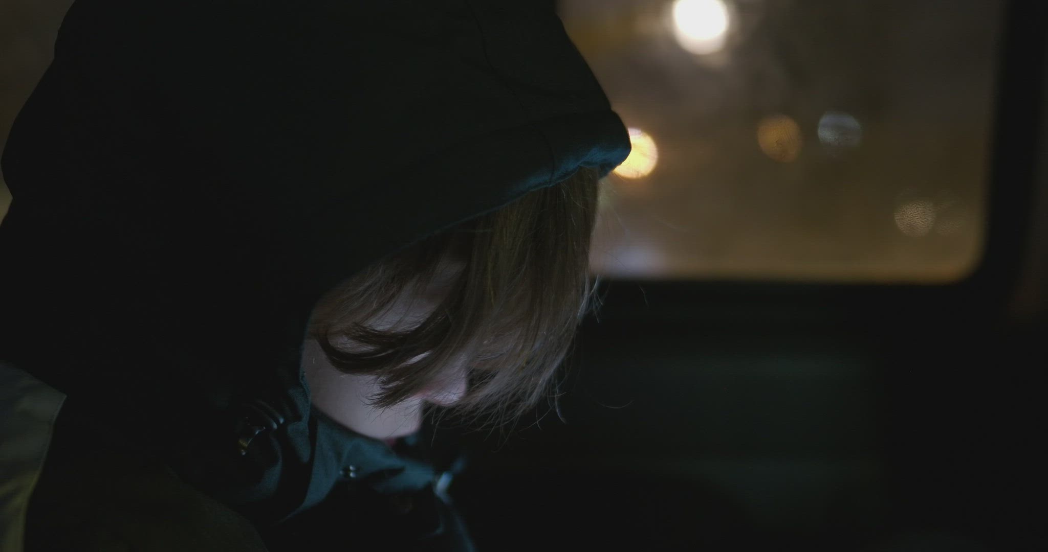 Boy traveling by car at cold night