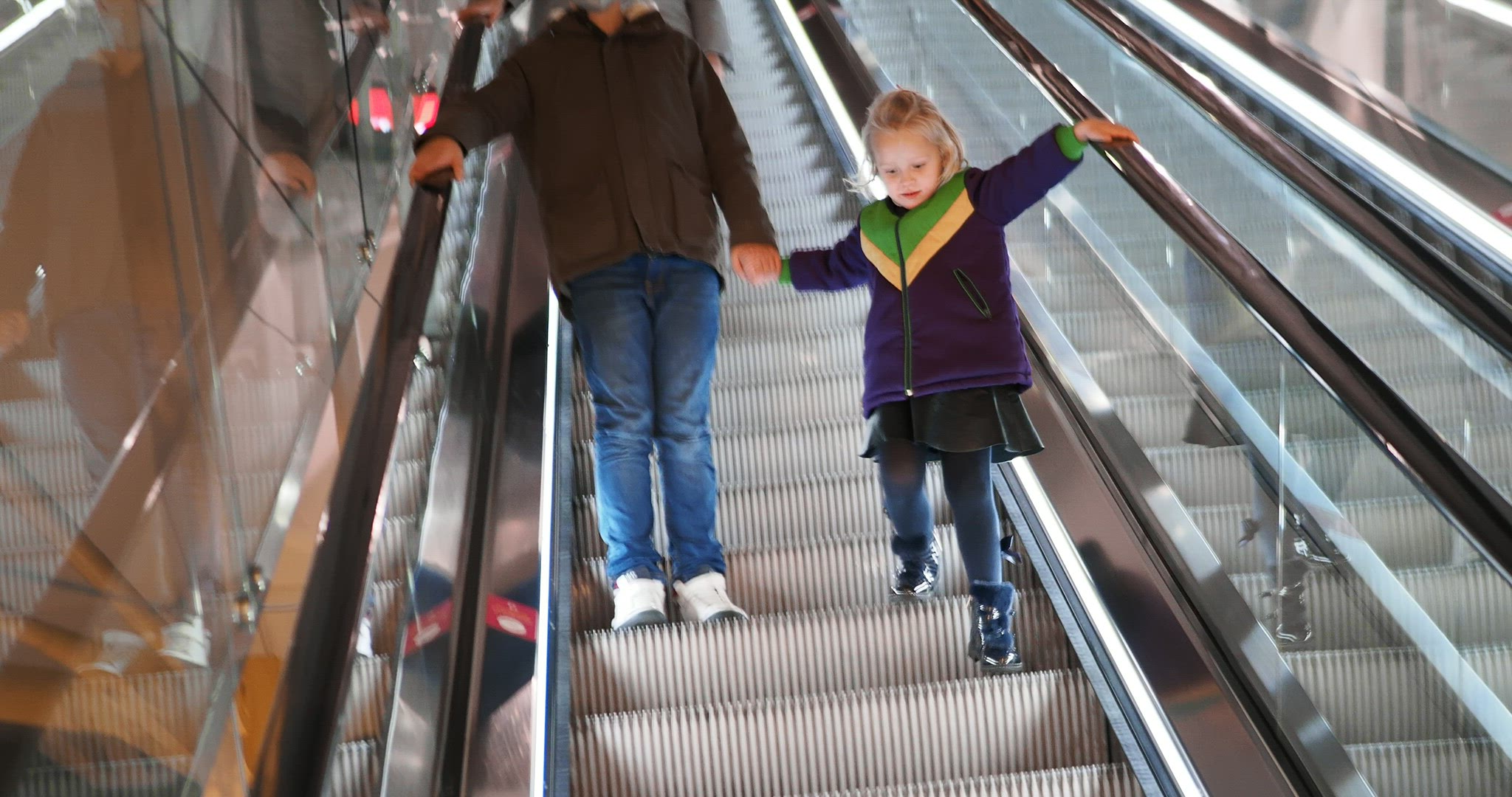 Brother and sister on the escalator