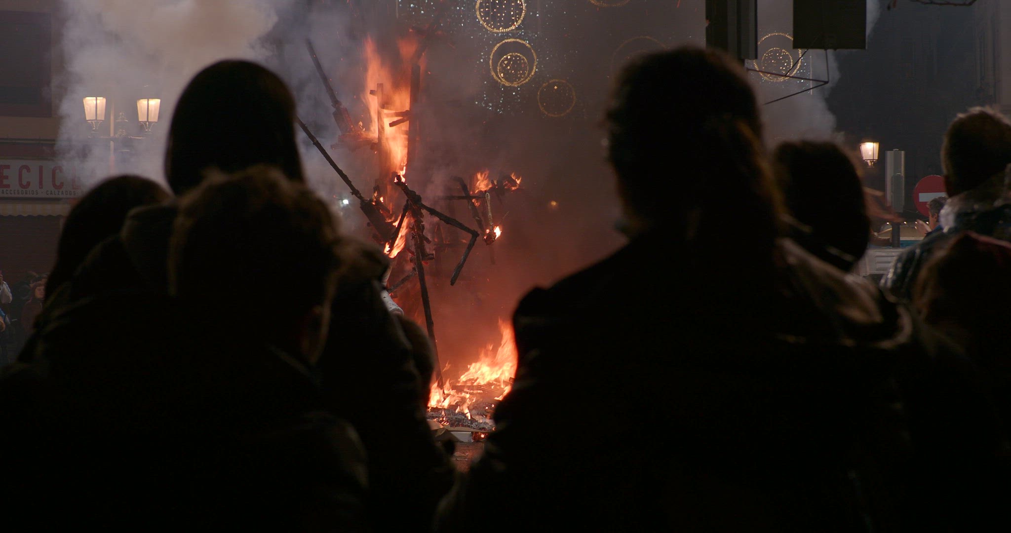People gathering to look at ninot burning during Fallas festival, Spain