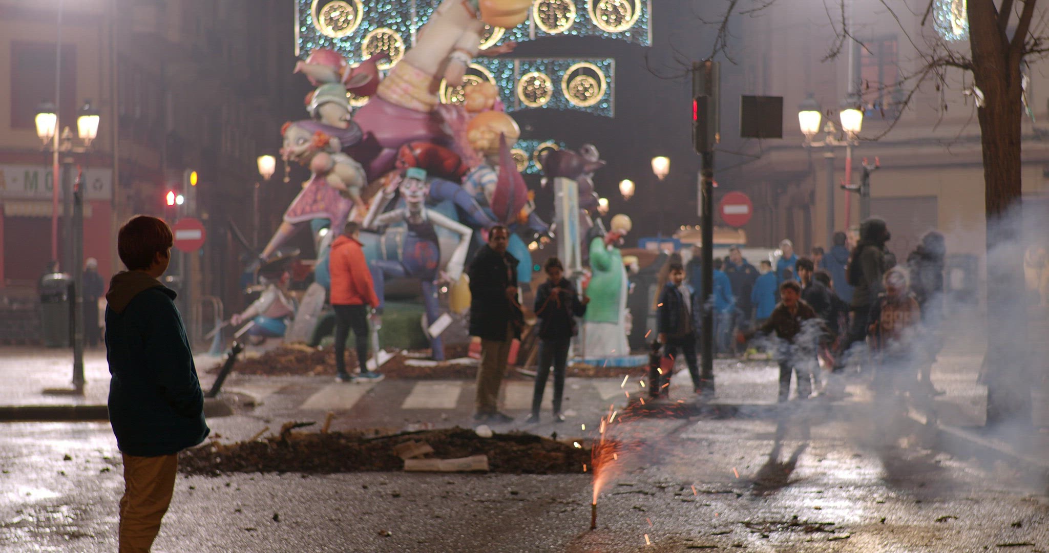 People celebrating Fallas with street fireworks, Spain