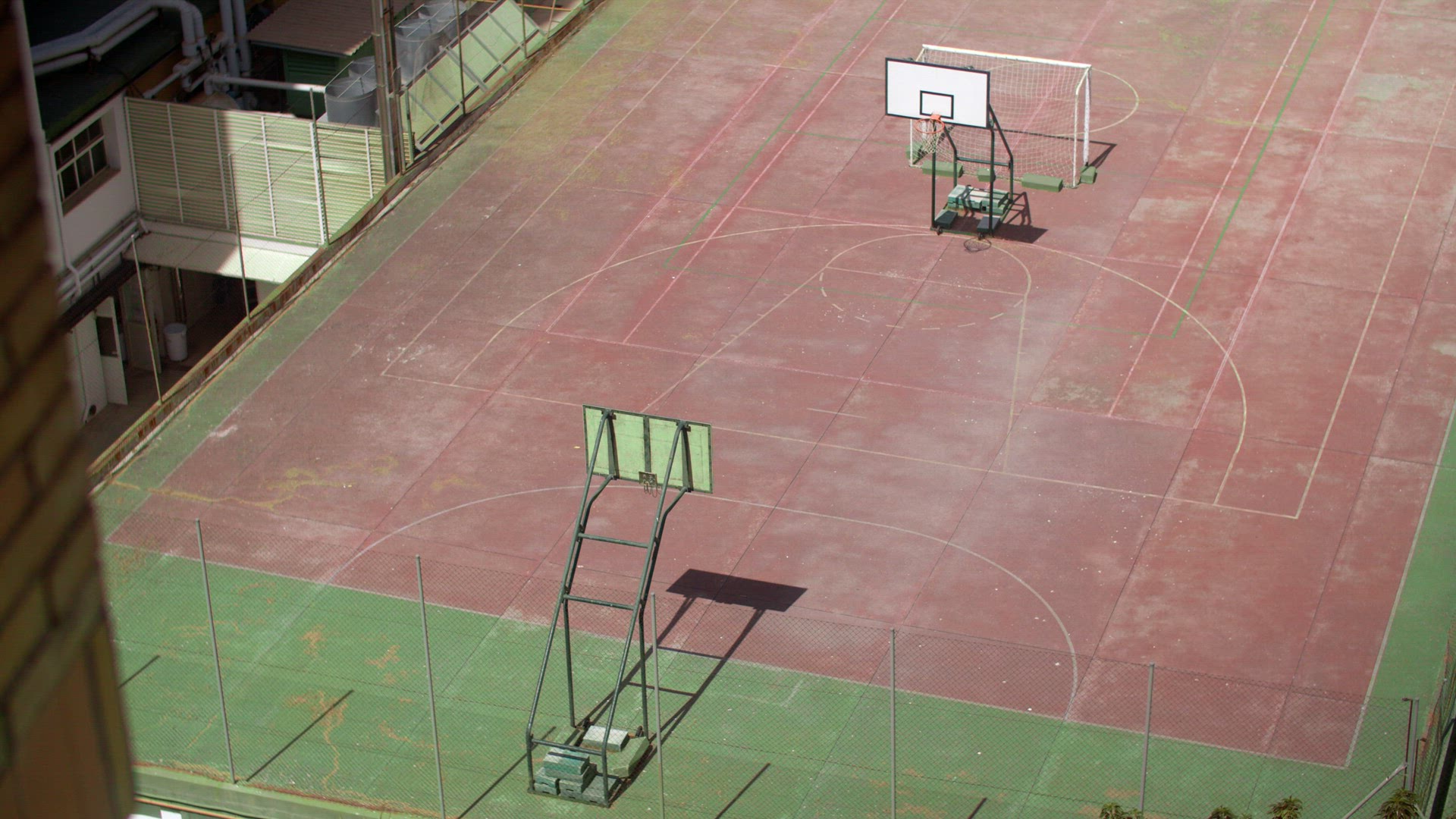 Empty basketball court on the roof, view from the house window