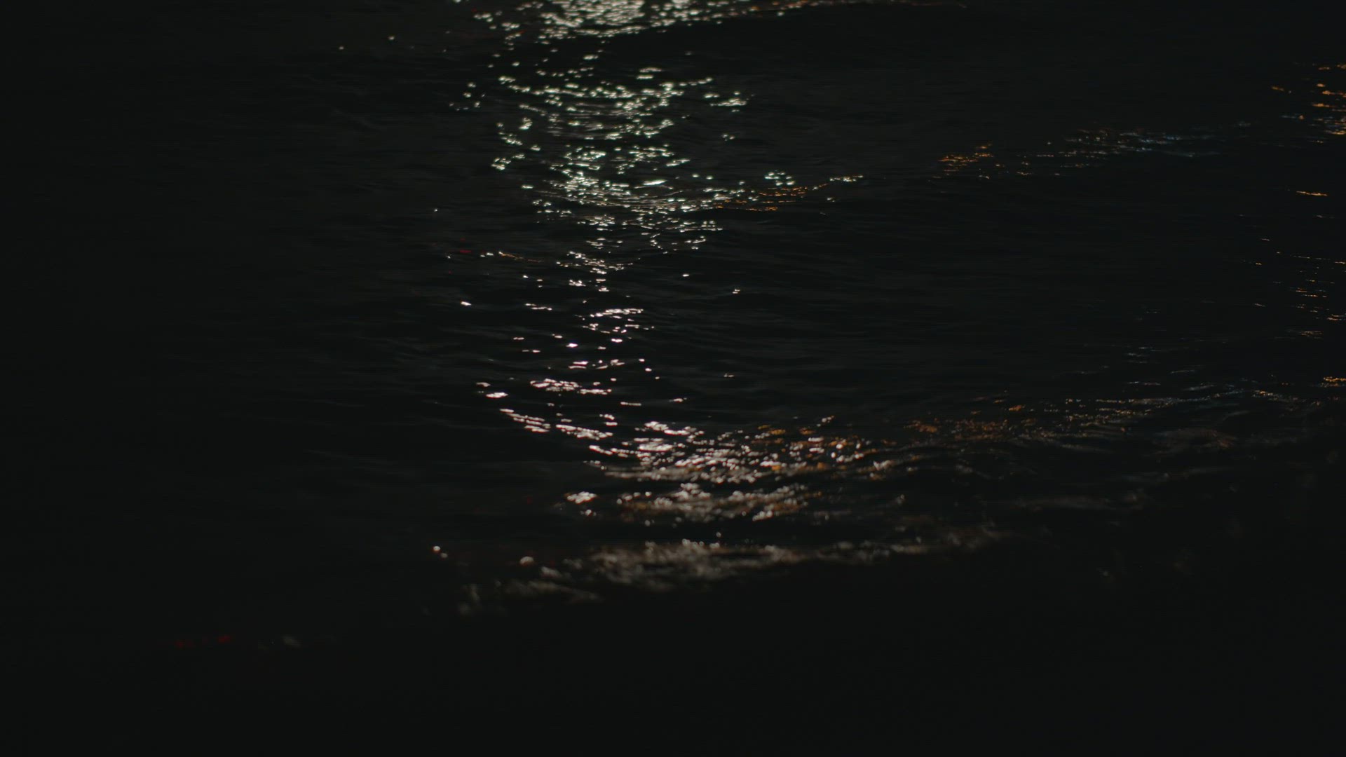 Moonlight sparkling on sea waves at night