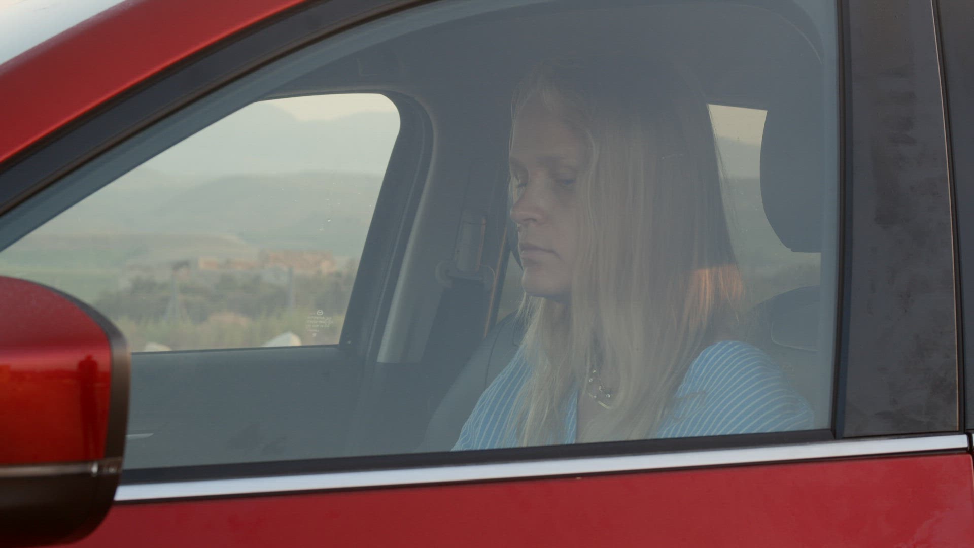 Woman car traveler taking a rest with hot tea