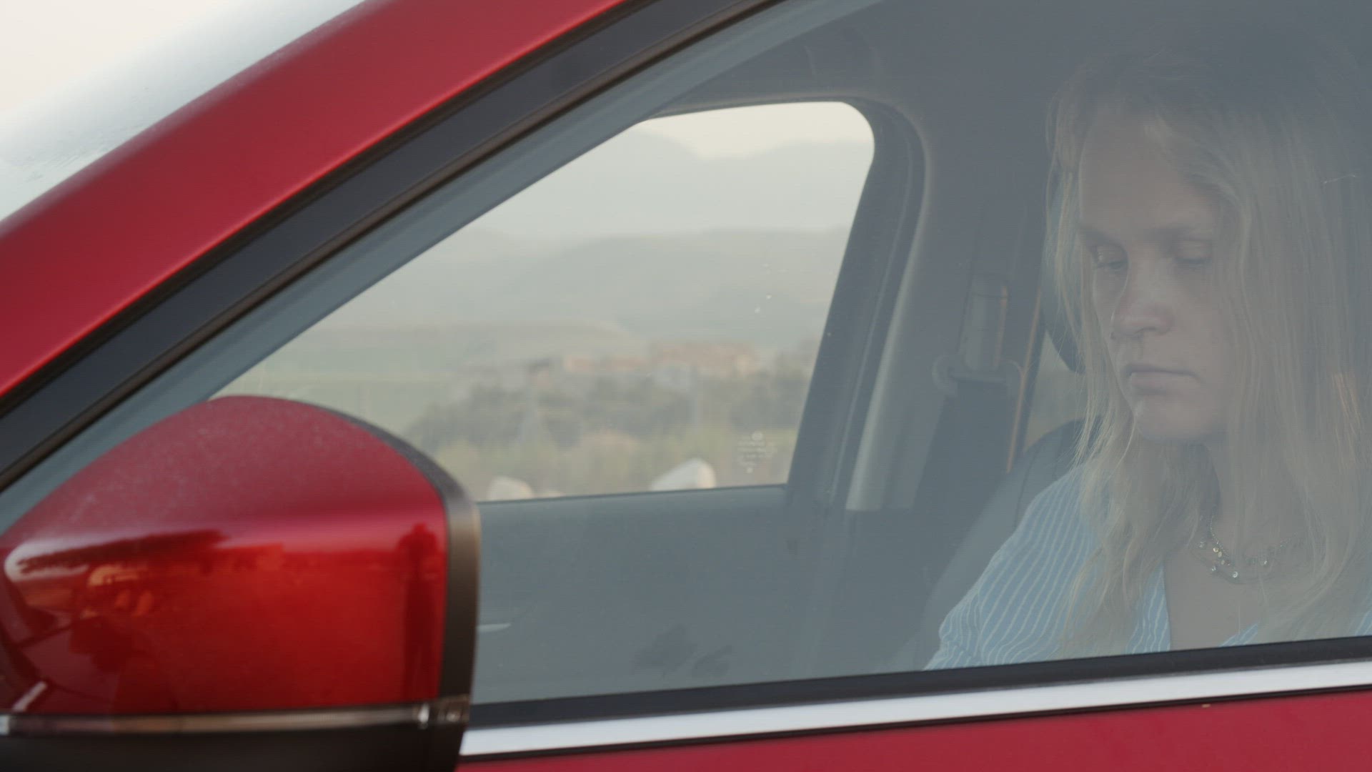 Woman car driver using smartphone