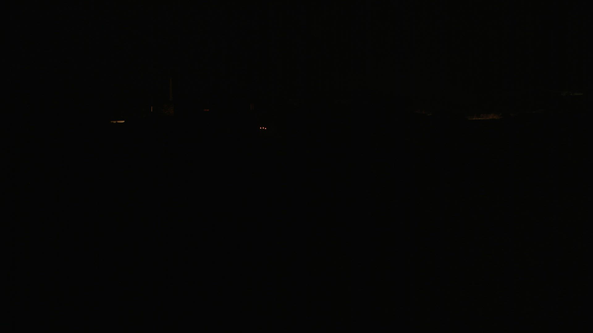 Lorry moving on remote road in total darkness of the night