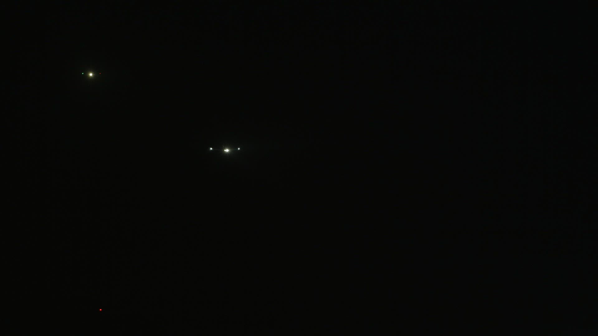 Three airplanes in the night sky