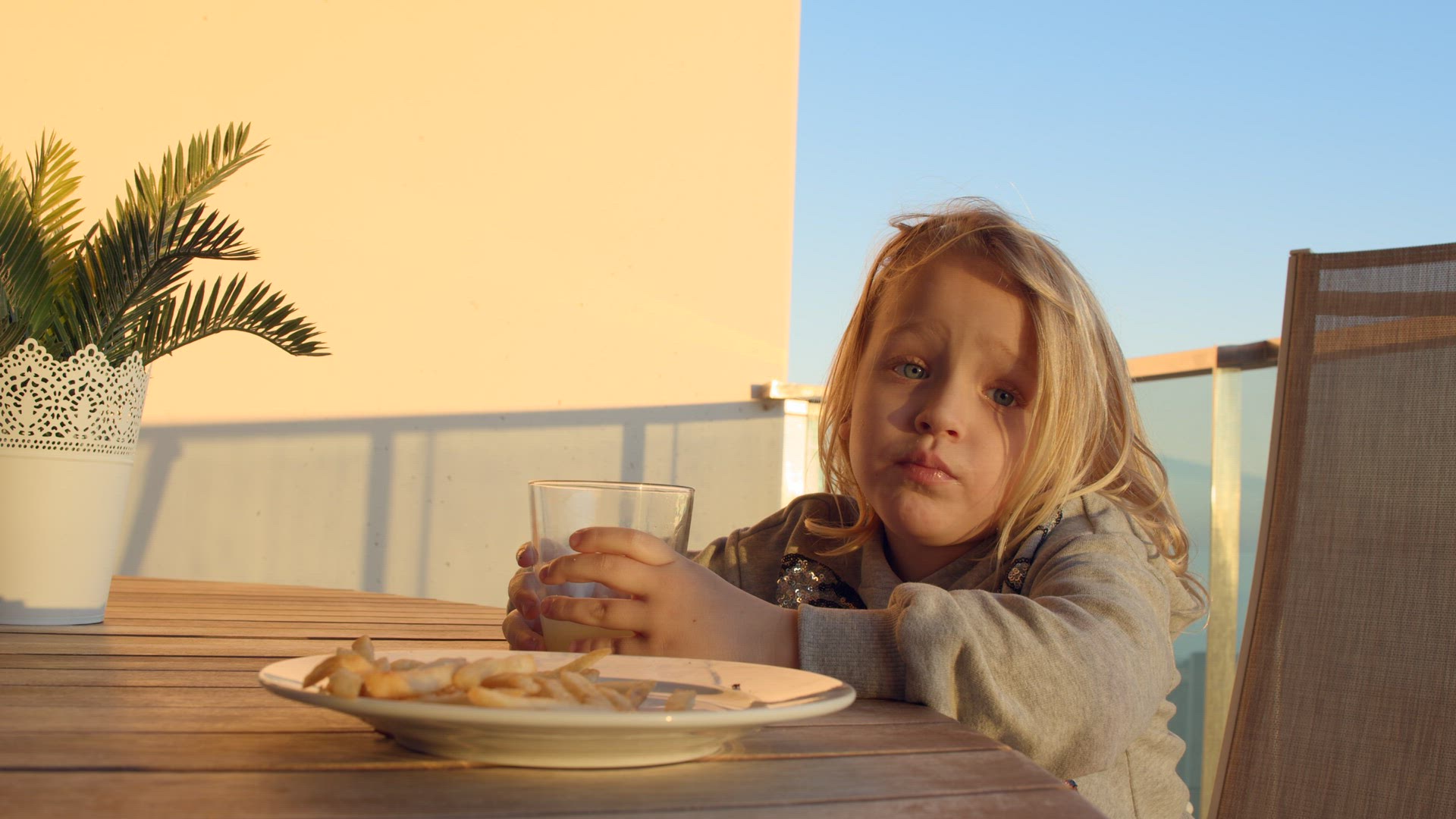 Child finishing her meal on the balcony