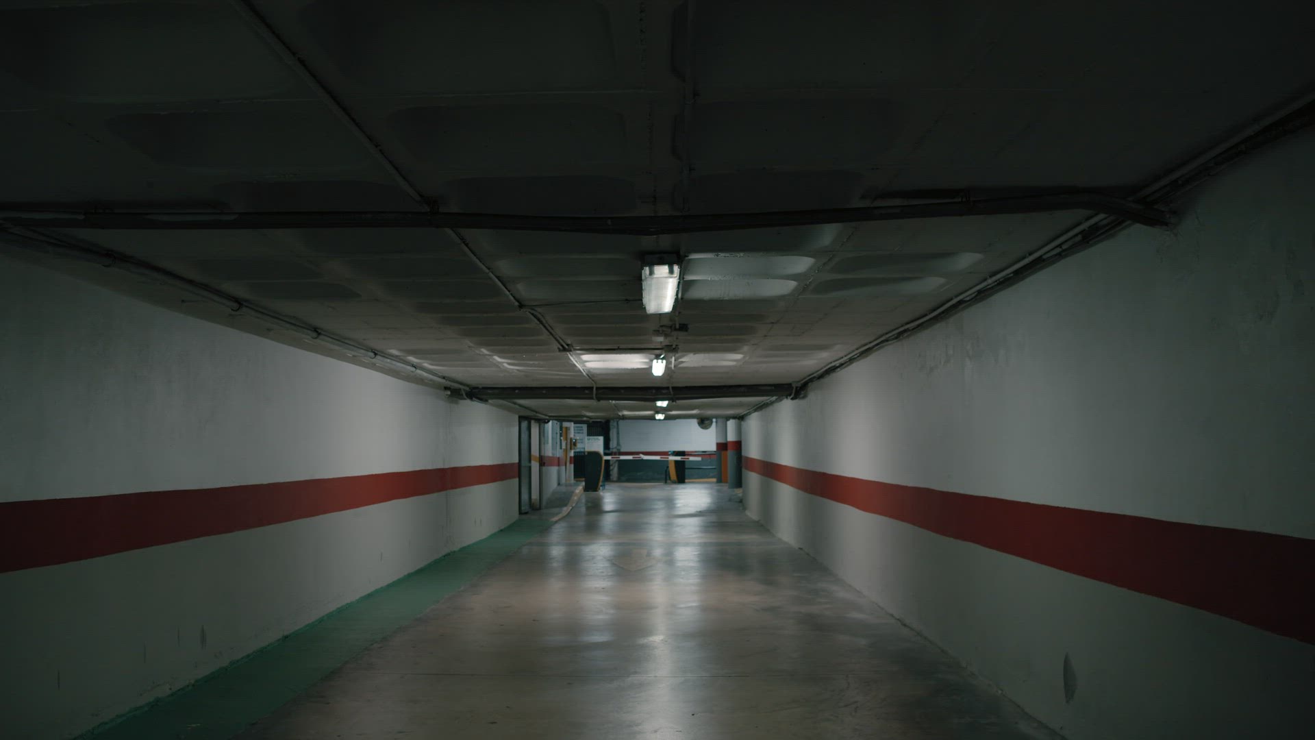 Flickering light in gloomy space of underground parking lot